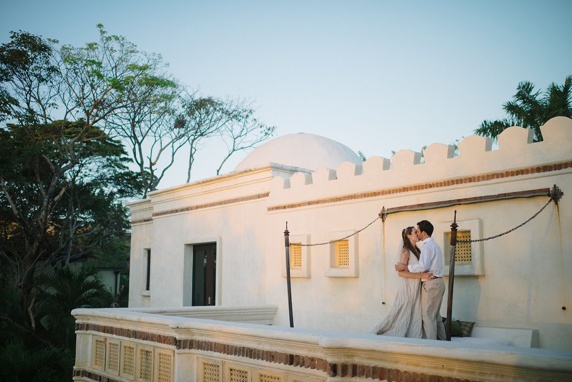 A couple on the rooftop of a white villa