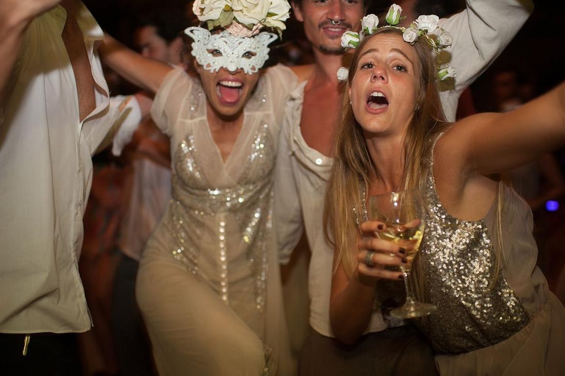 Guests in masks dancing at a reception