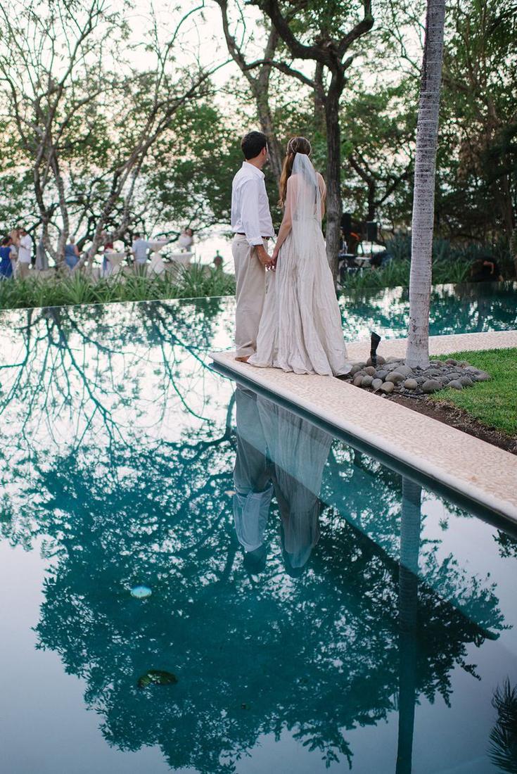 A couple reflected in an infinity pool