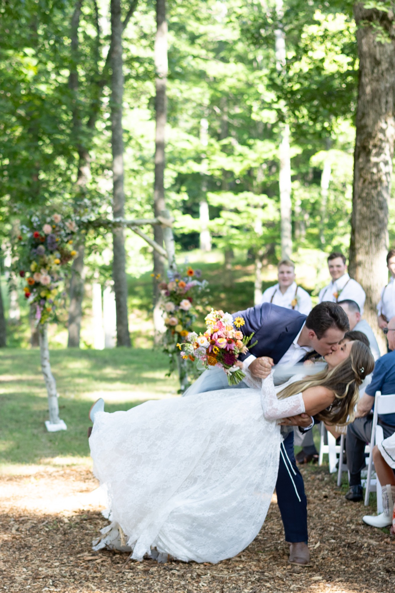 The bride's dress sweeping past guests during the ceremony