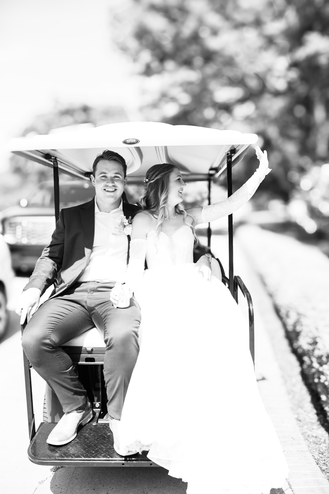 The couple in a golf cart, in black and white
