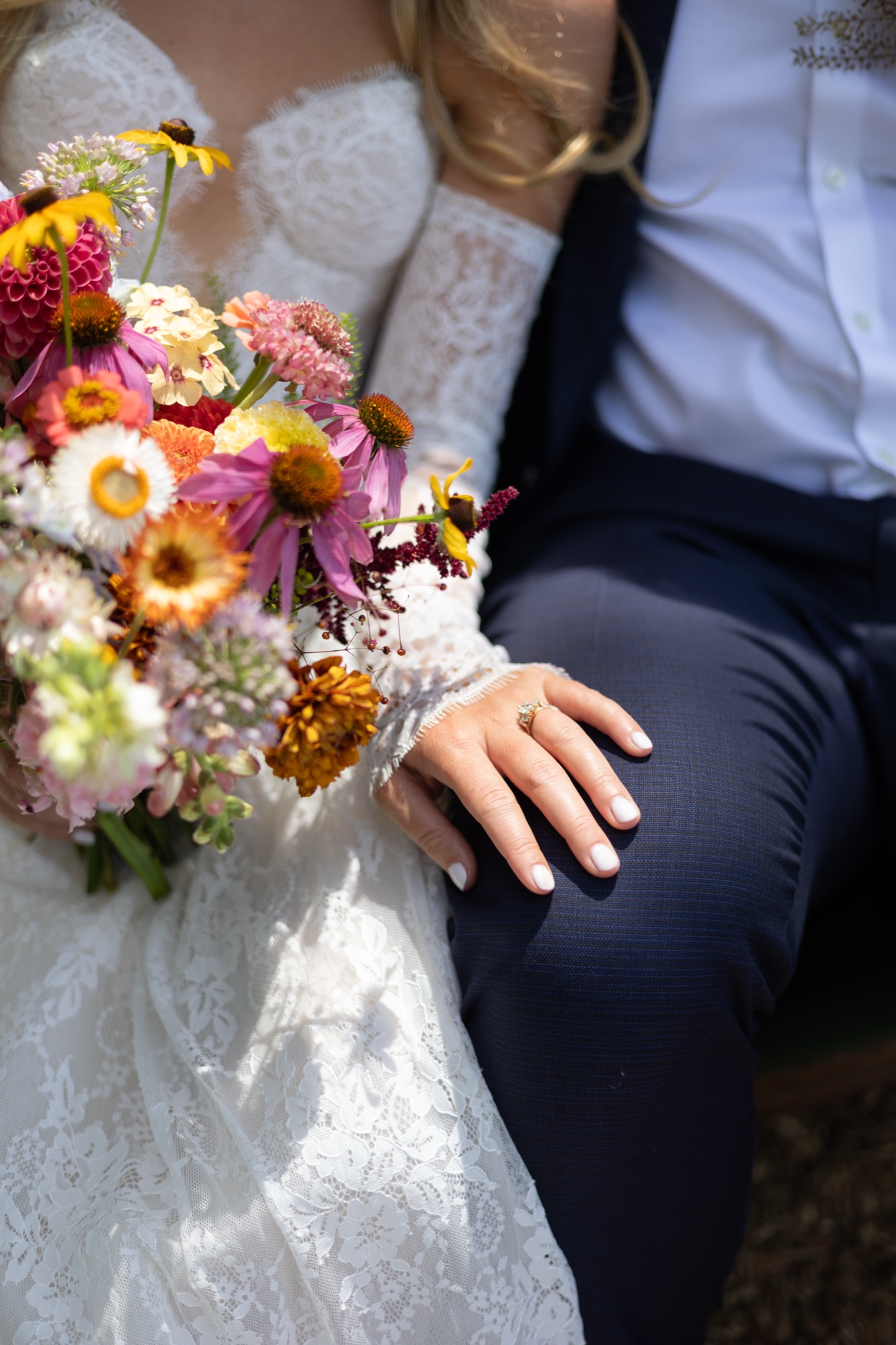 Her lace sleeves and a bouquet of zinnias