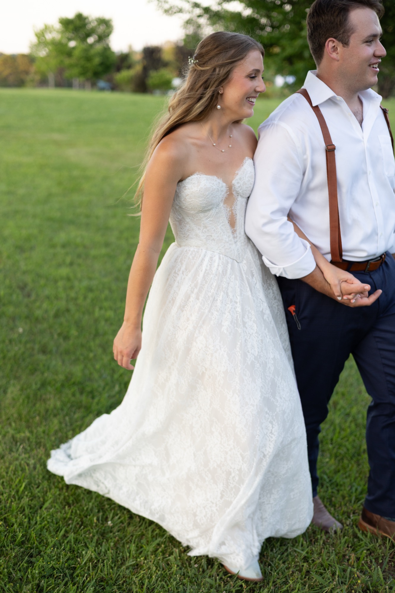 The couple laughing on the lawn at sunset