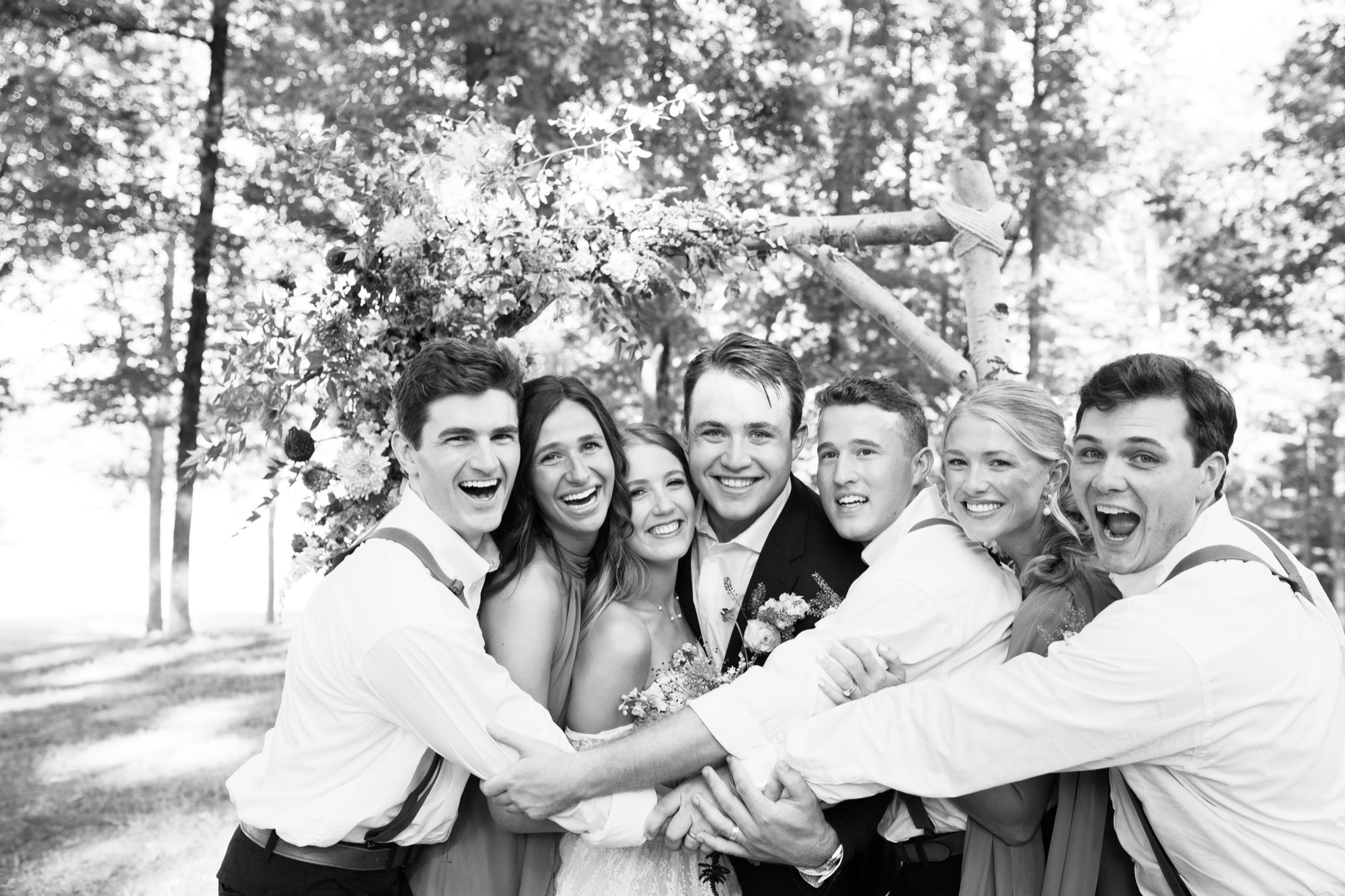 The groomsmen and friends shouting, in black and white
