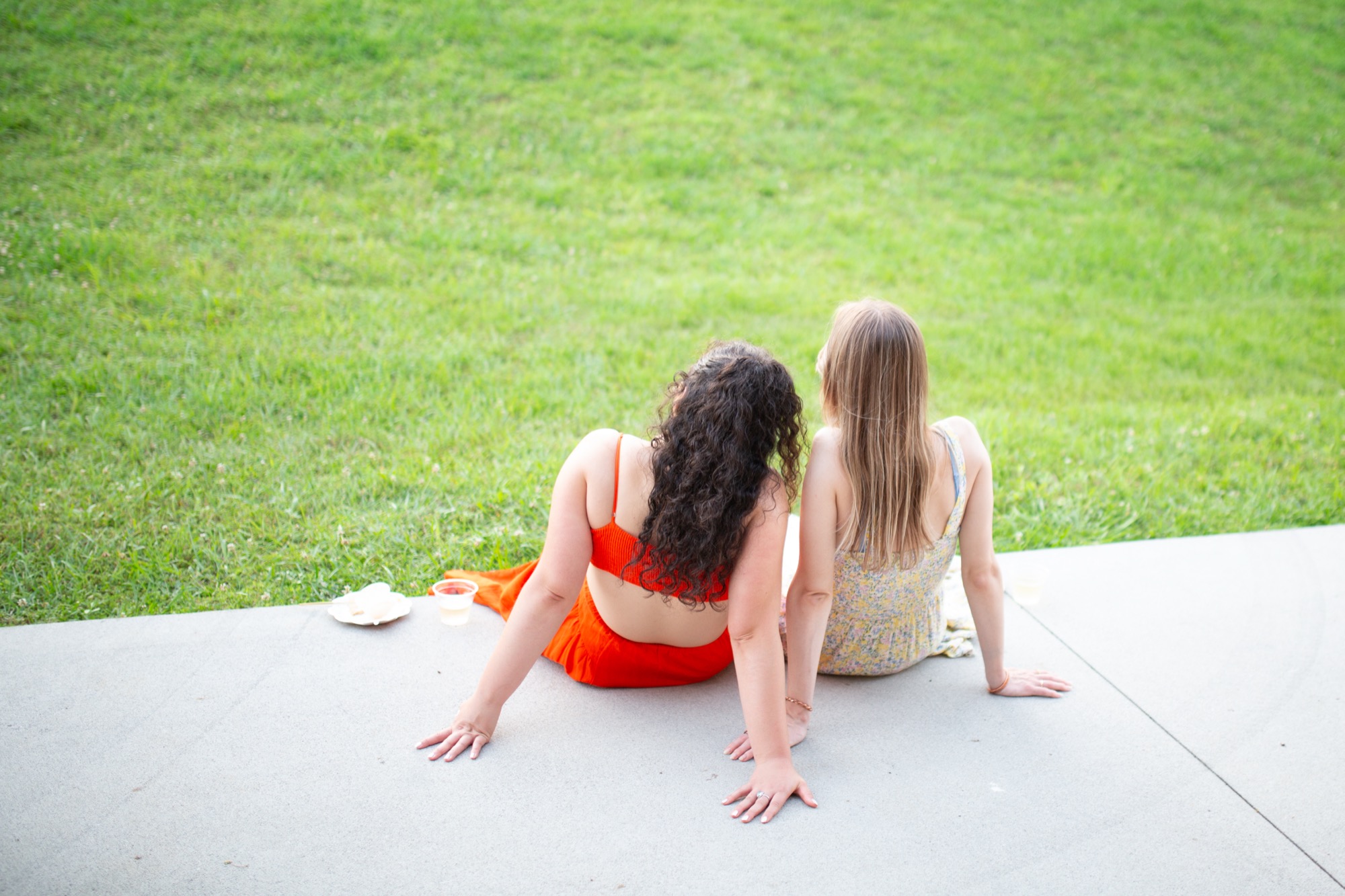 Two friends sitting on the grass