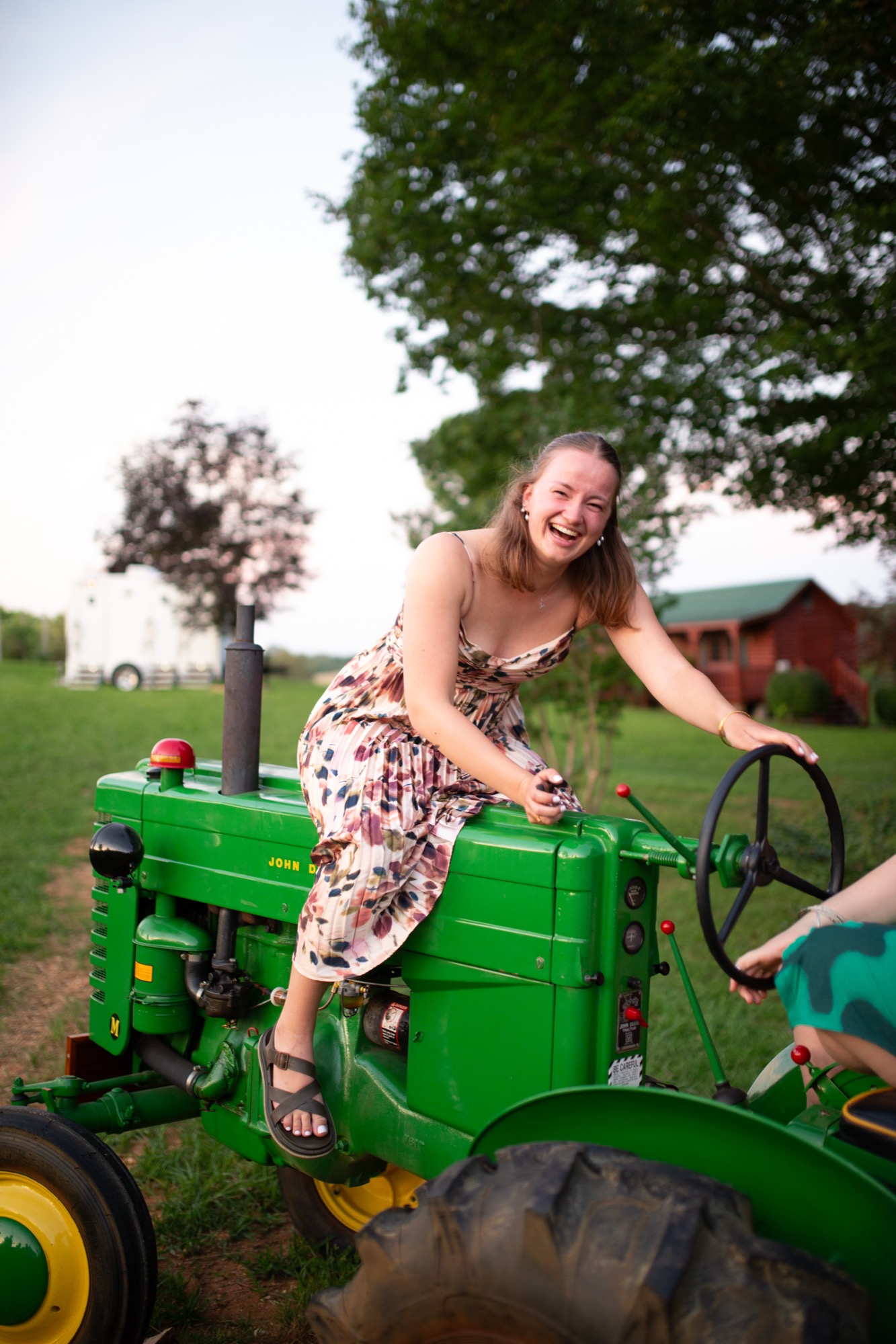 A bridesmaid on a green tractor