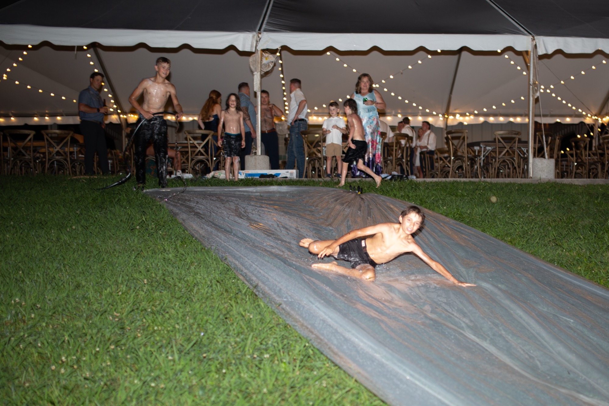 A guest on the slip and slide after dark