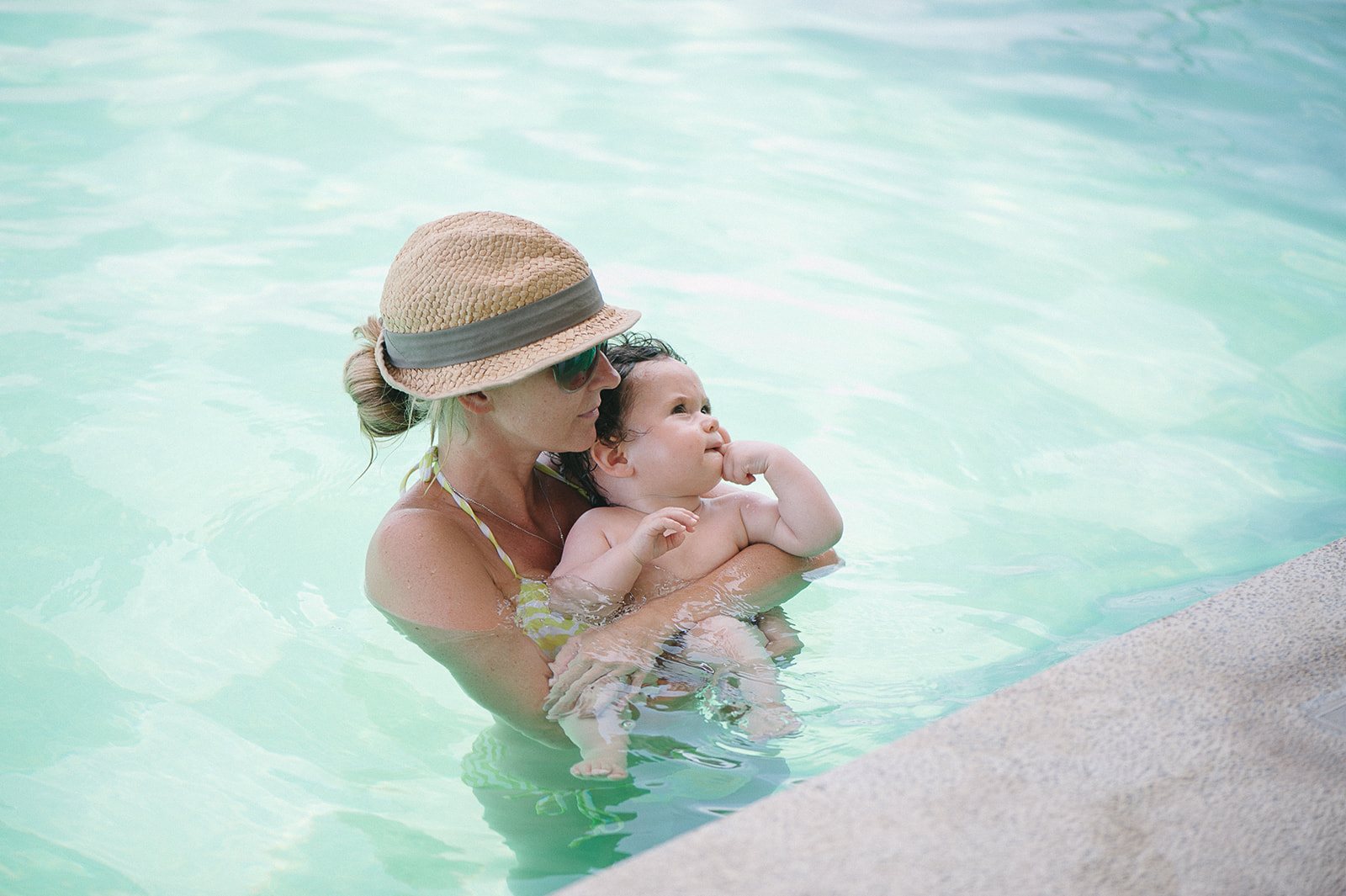 A mother and baby in a turquoise pool