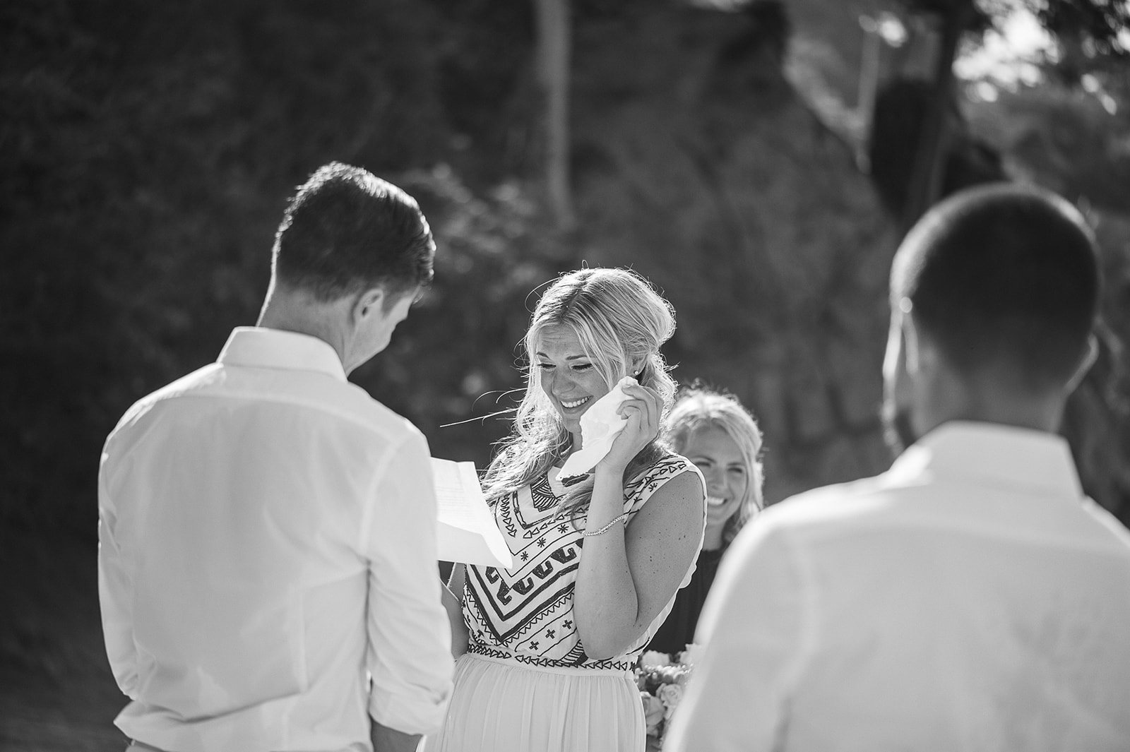 The couple reading their vows, in black and white