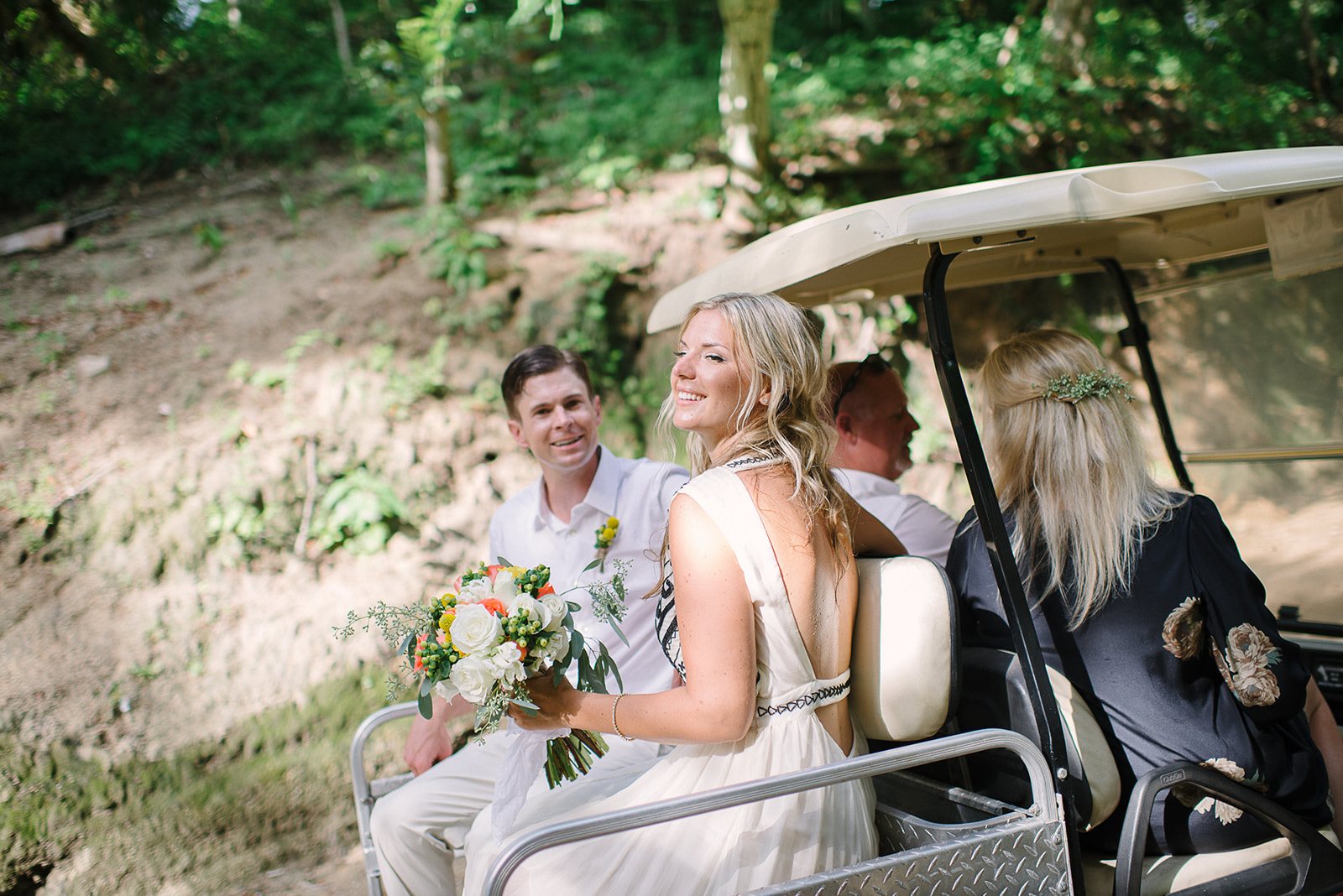 The couple in a golf cart after the ceremony