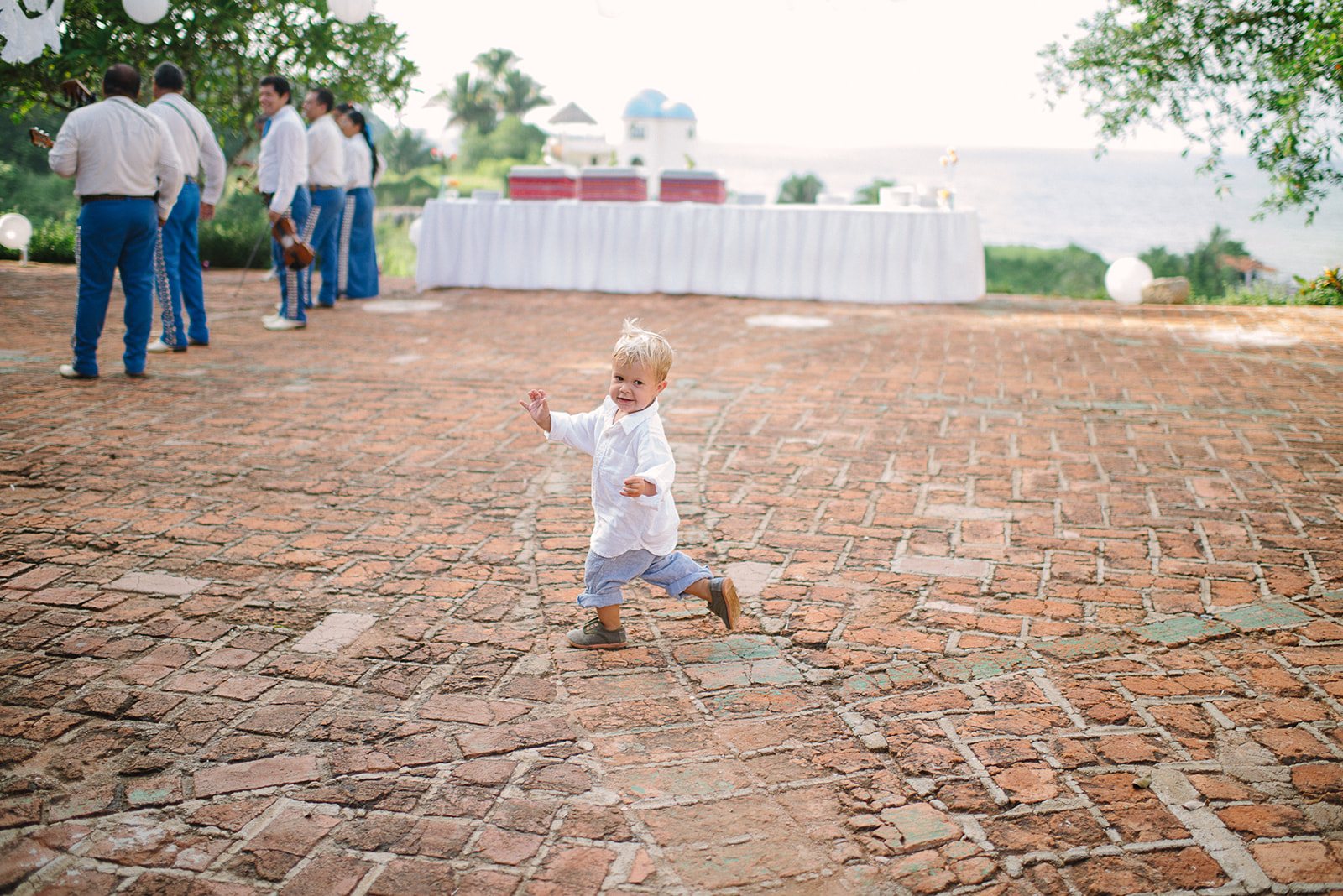 A little boy running across the courtyard
