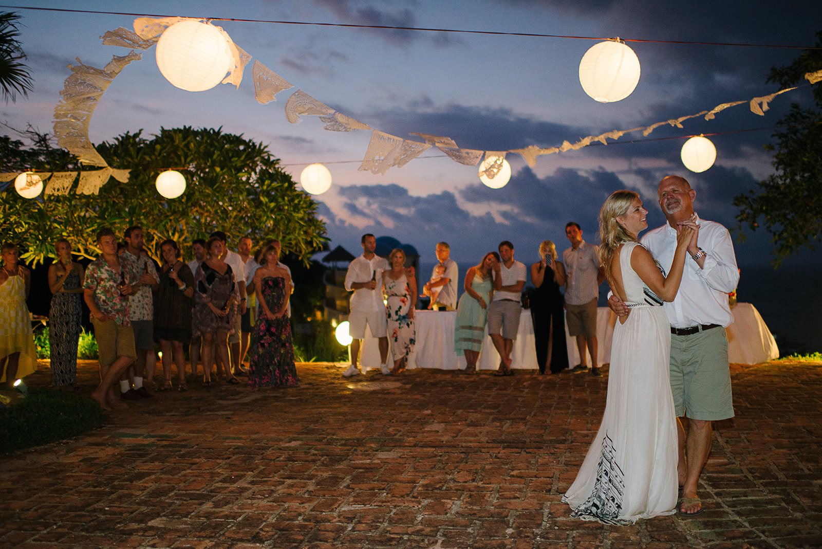 A first dance under paper lanterns at dusk