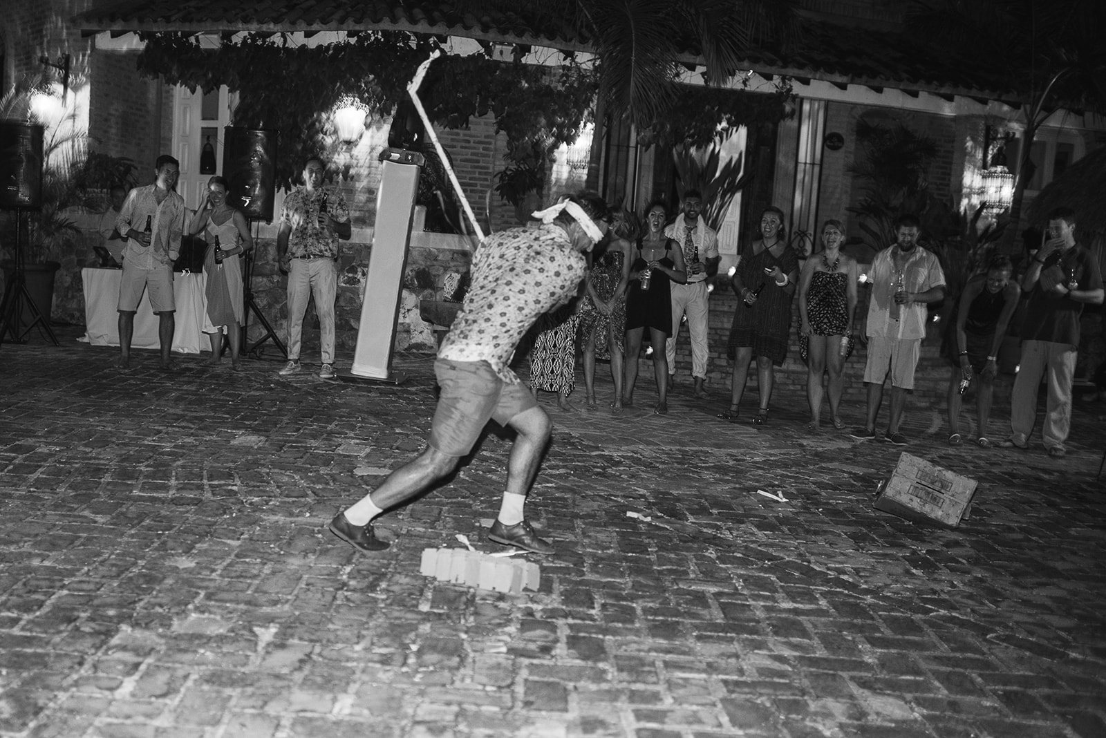 A guest dancing low, in black and white