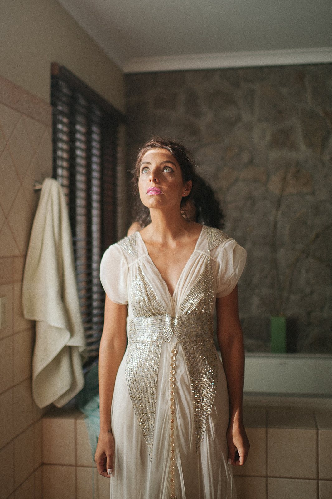 The bride in her gown in a quiet bedroom