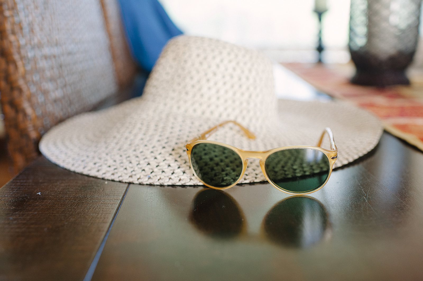 A straw hat and sunglasses on the table