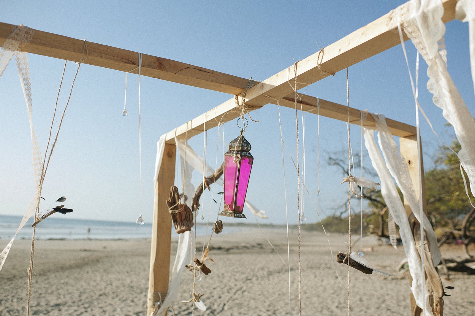 The driftwood arch with ribbons in the wind