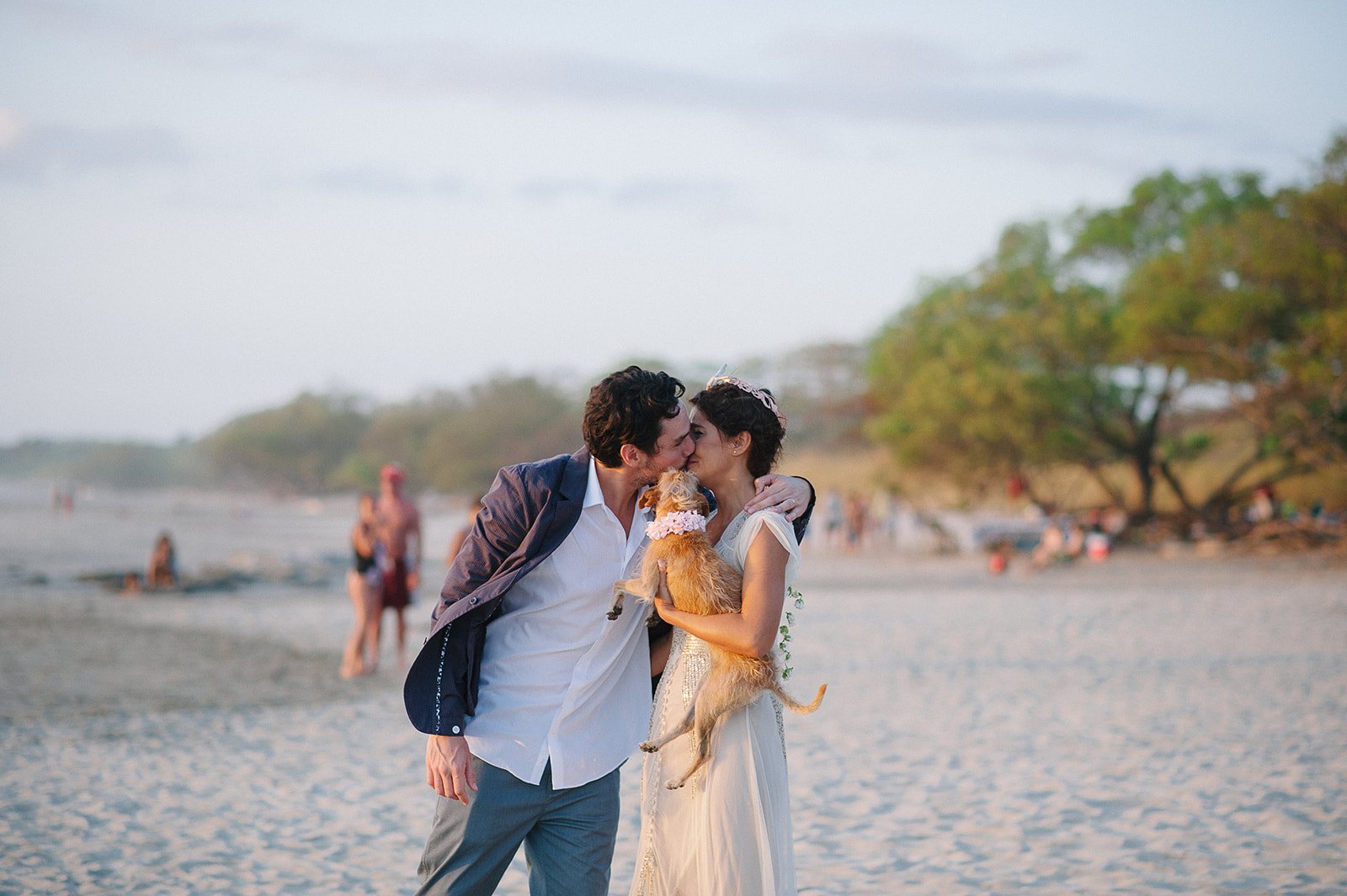 The couple kissing on the beach at dusk