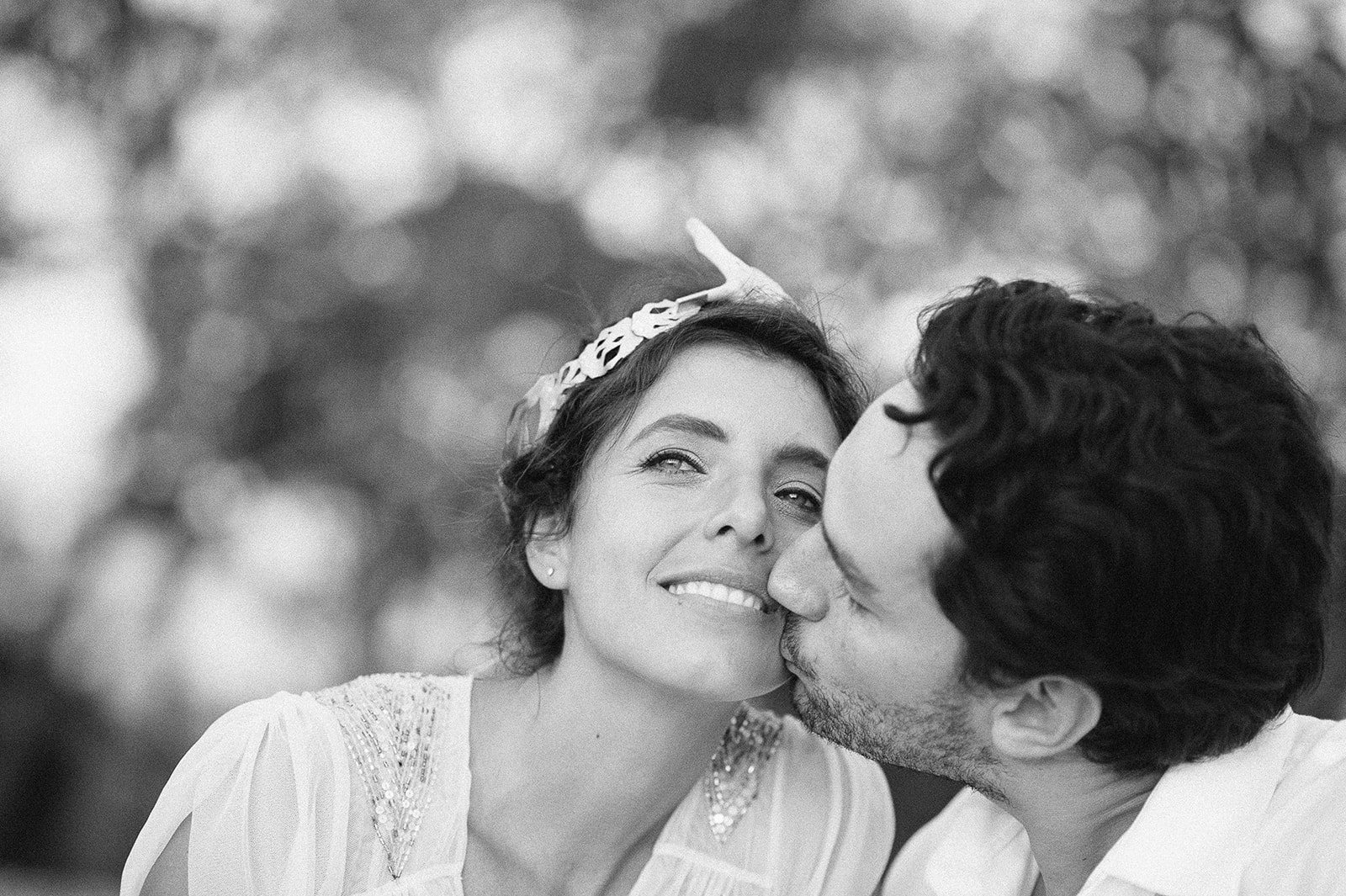 The couple cheek to cheek, in black and white