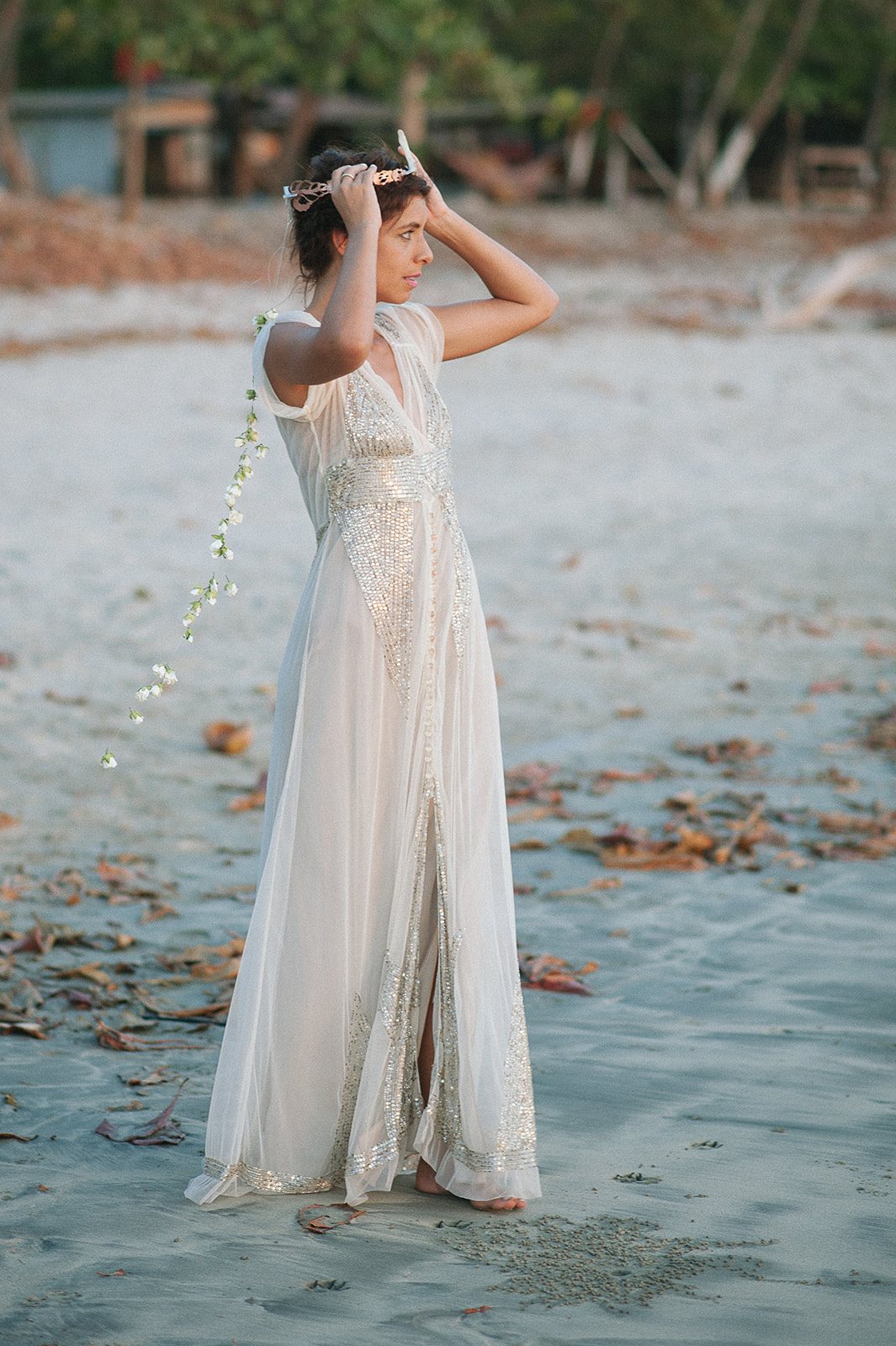 The bride on the sand with her arms up