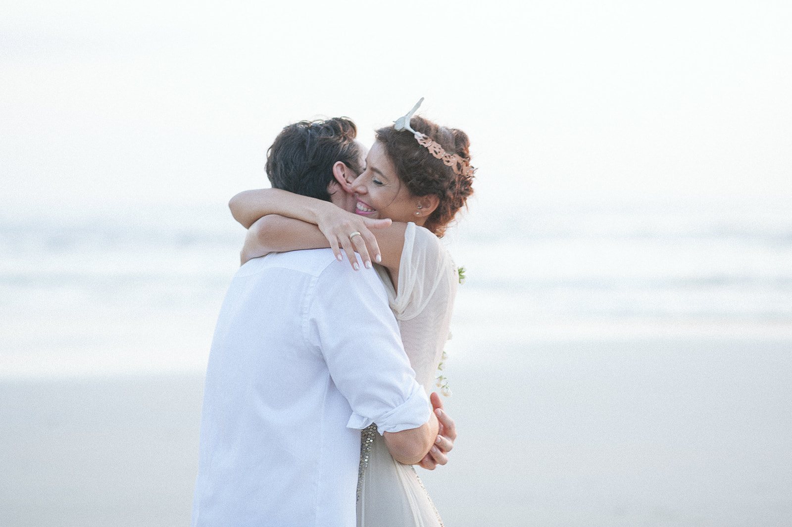 The couple embracing by the sea