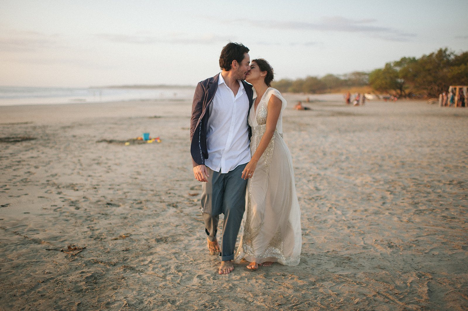 The couple strolling the beach at sunset