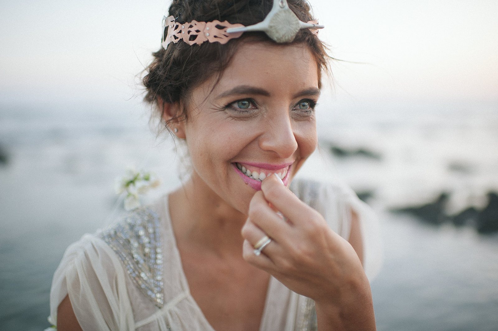 The bride laughing, flower crown askew