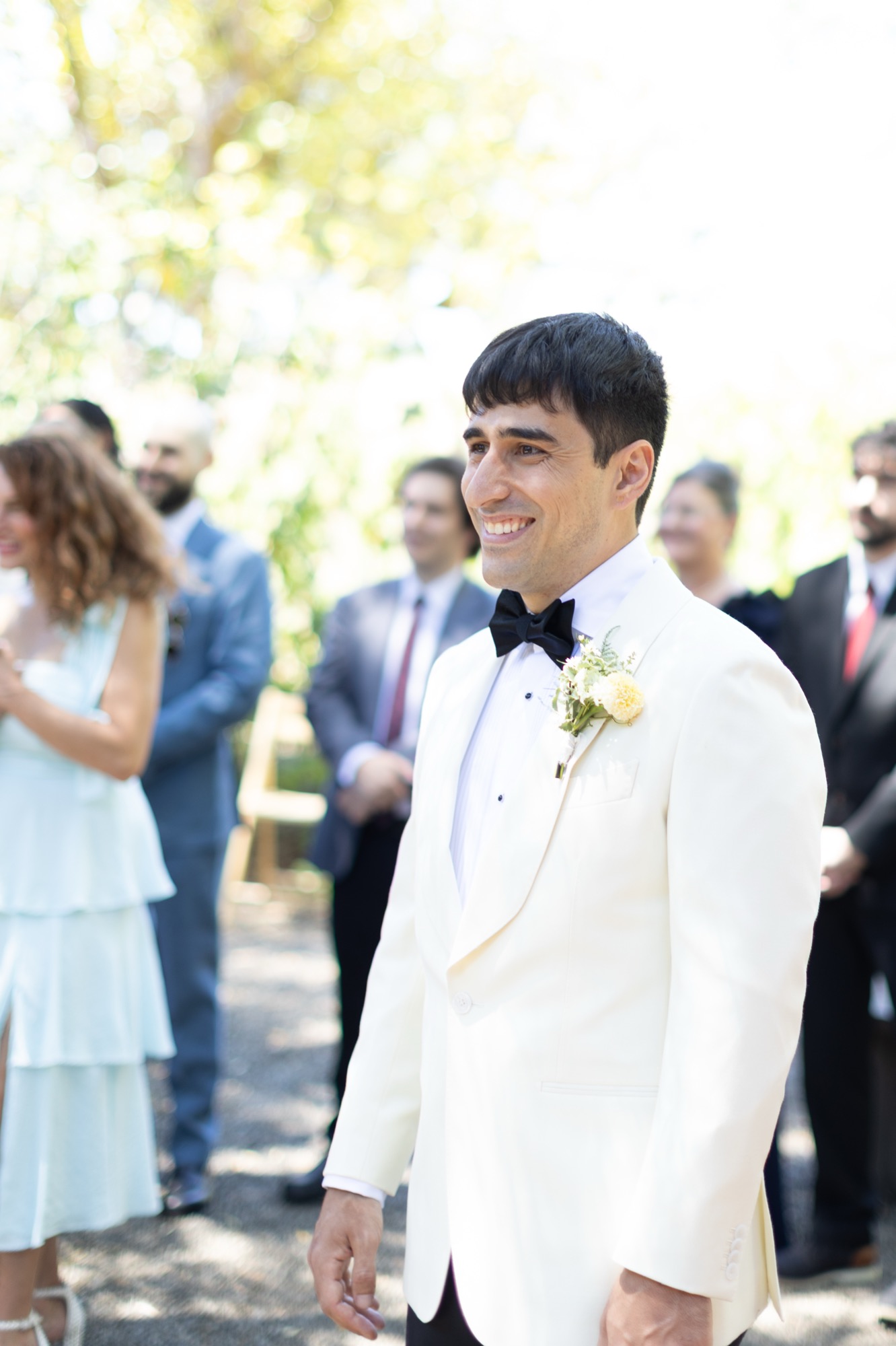 The groom in his white dinner jacket, waiting