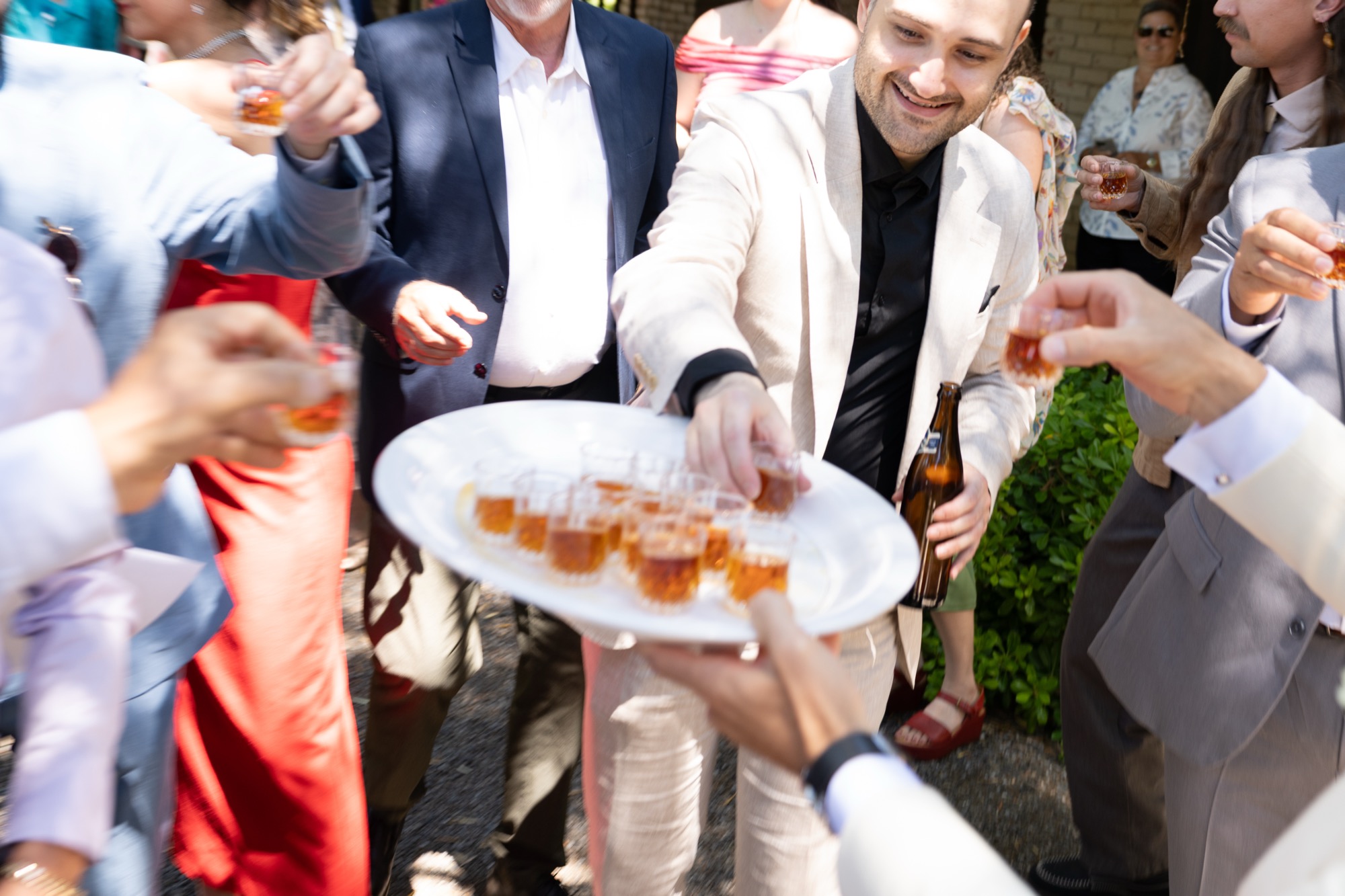 Hands reaching for a plate of snacks during cocktails