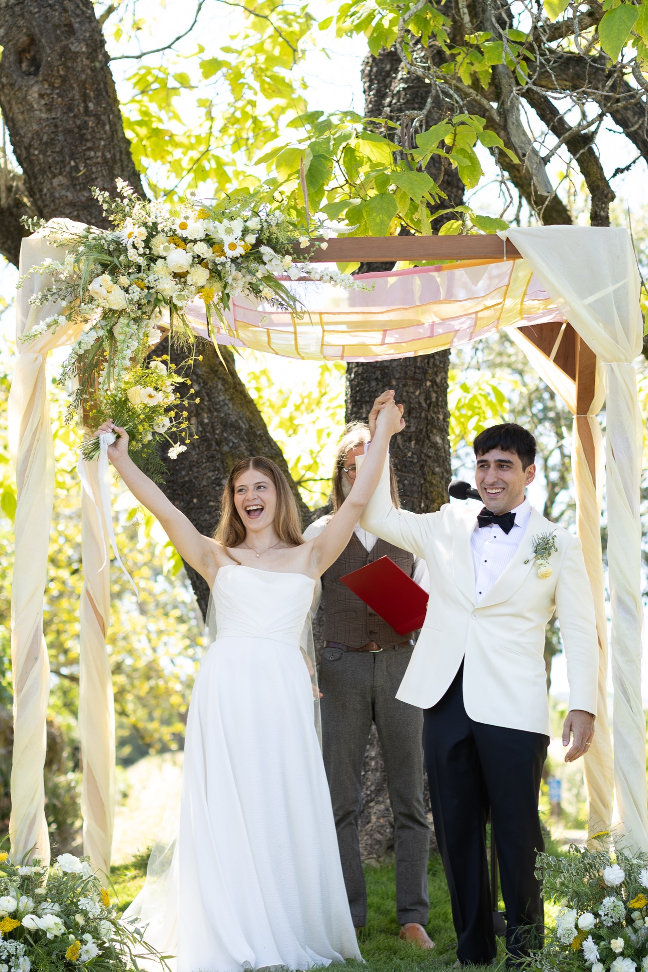 The couple throwing their arms up after the kiss