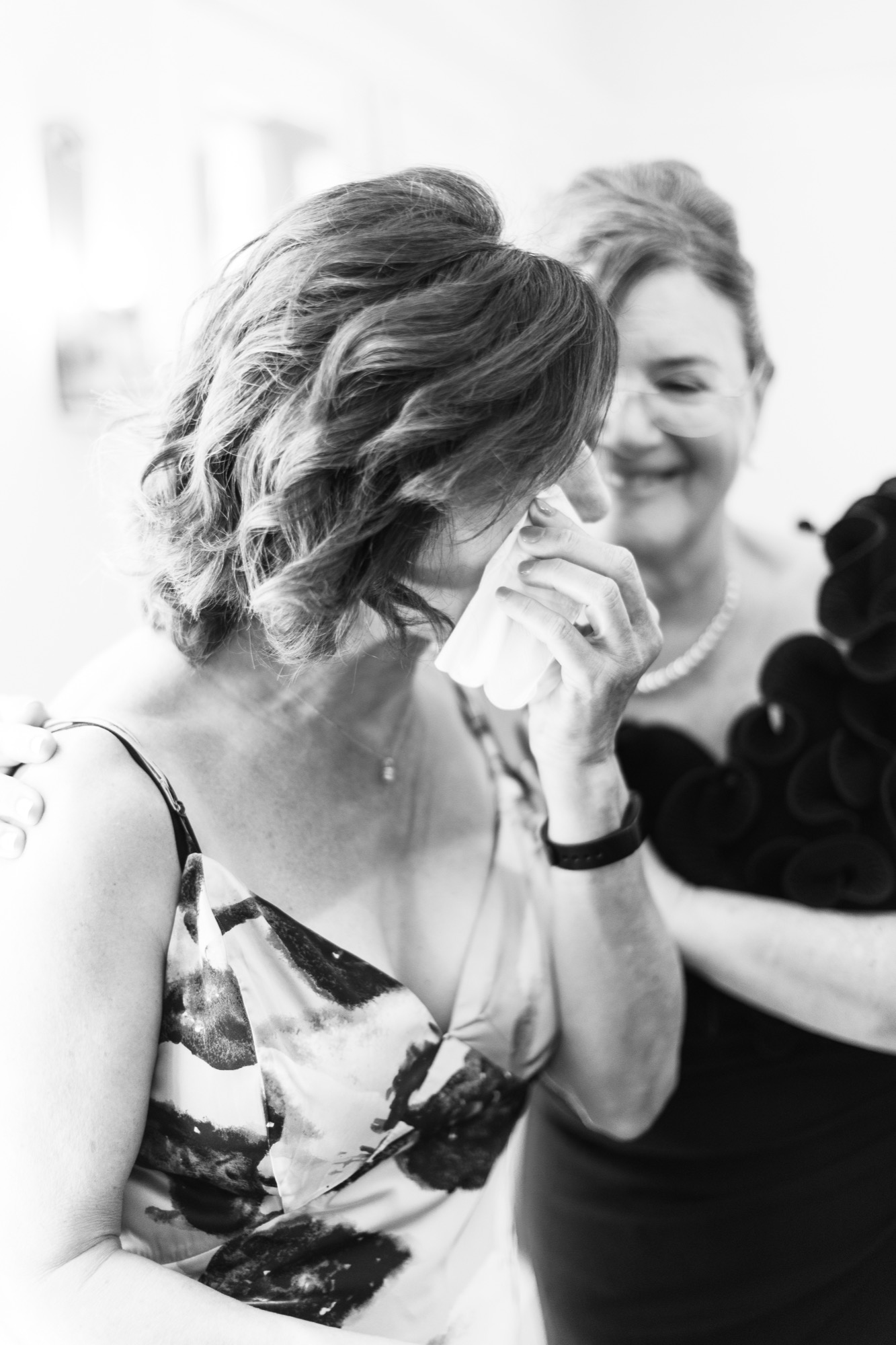 Her mother wiping away tears, in black and white