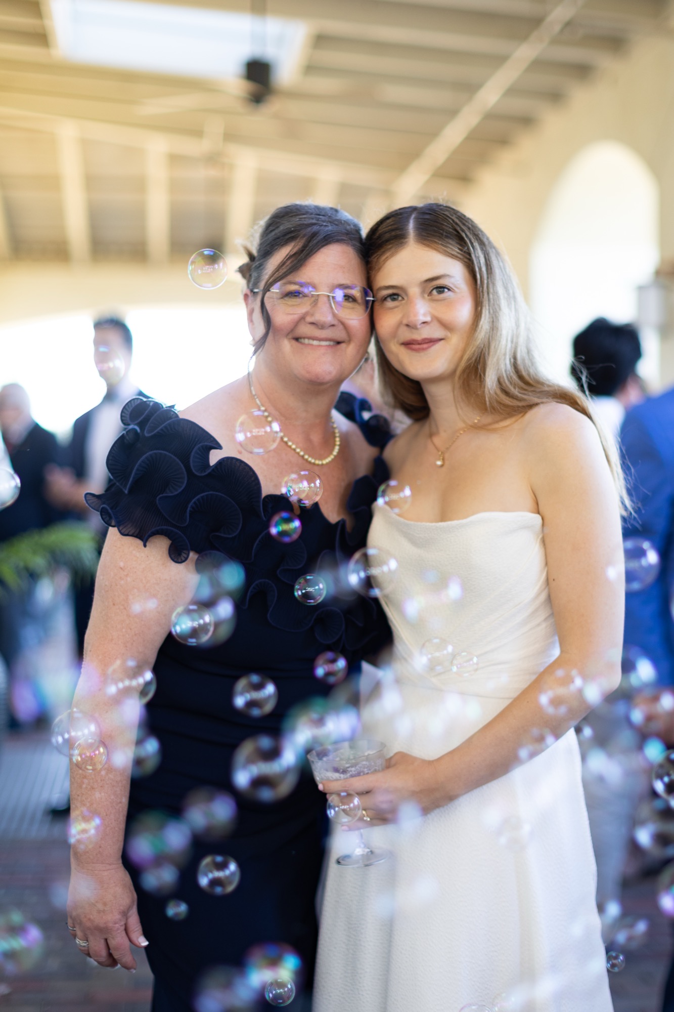 The bride and her mother in a stream of bubbles