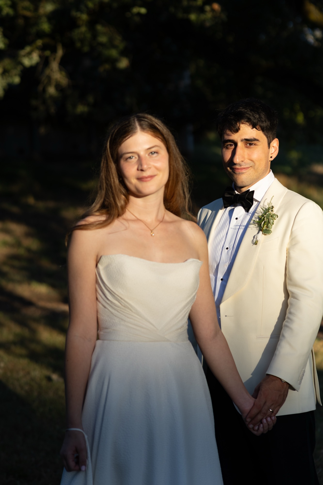 The couple in the last light against a dark garden