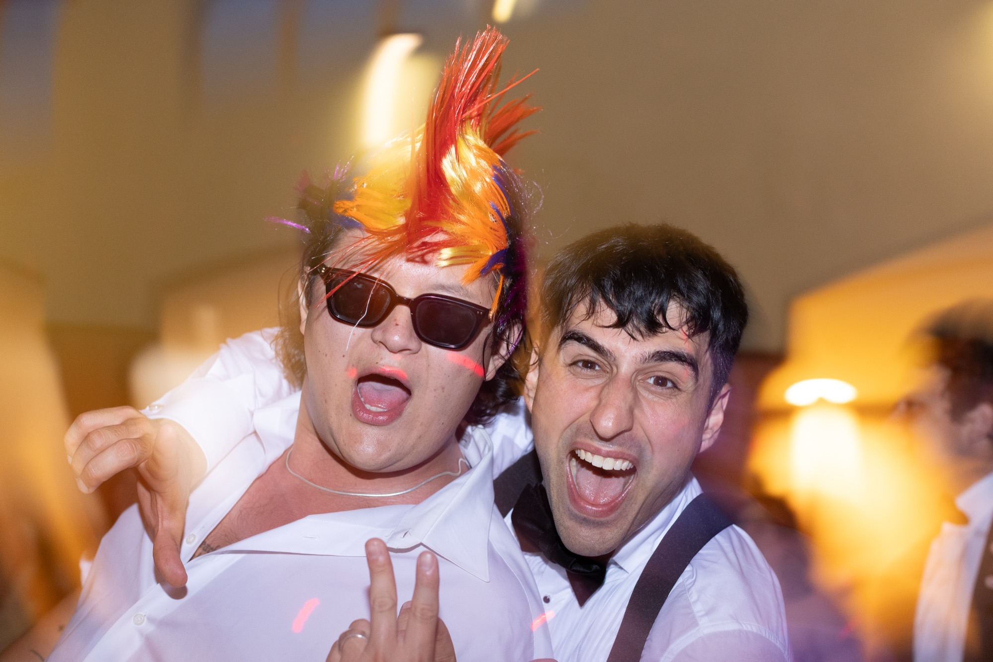 Guests in feathers and sunglasses from the prop box