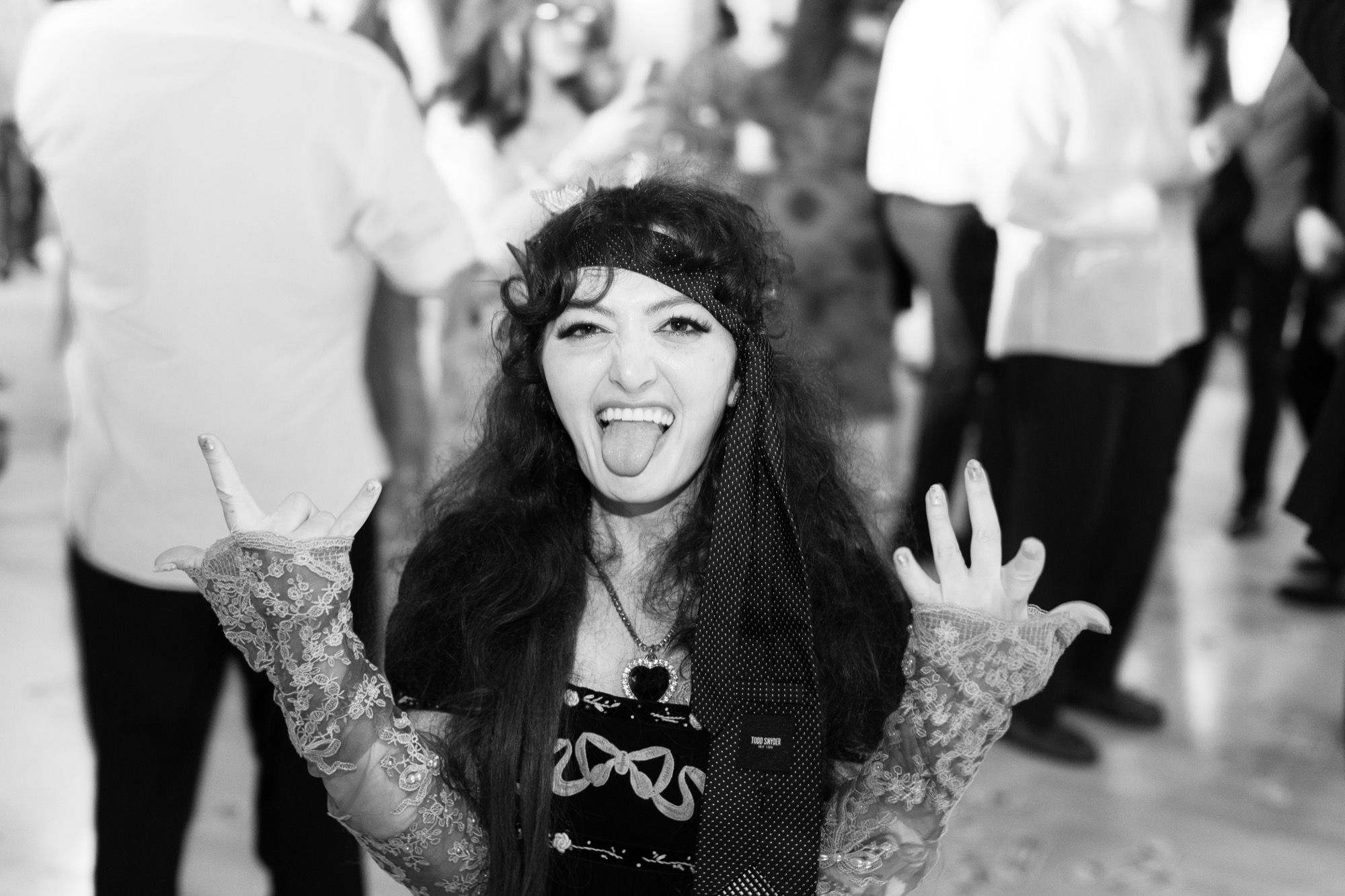 A guest mid-shout on the dance floor, in black and white