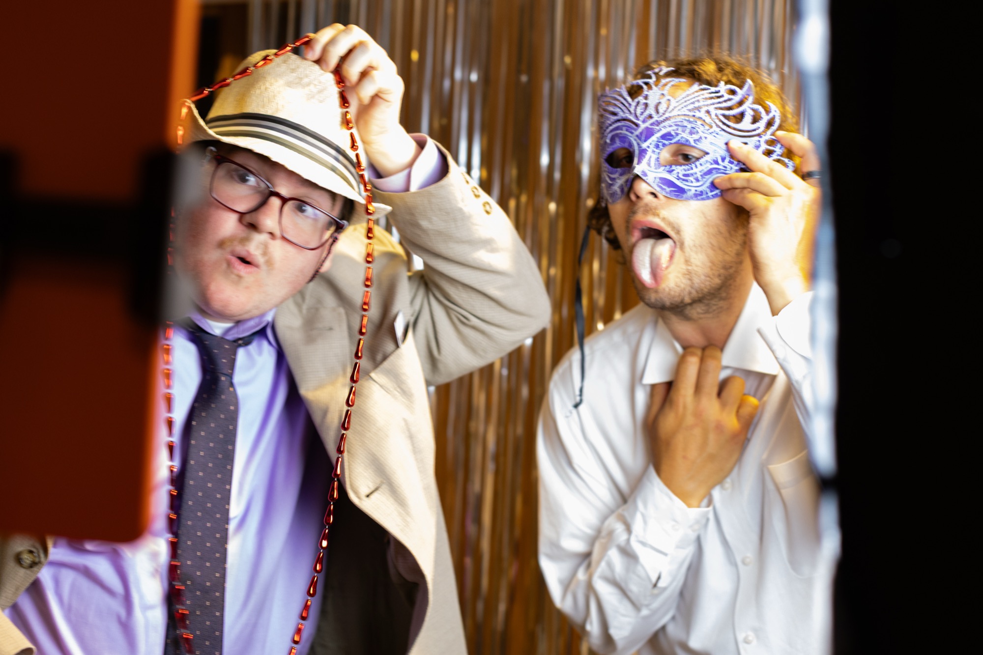 Guests posing with party props