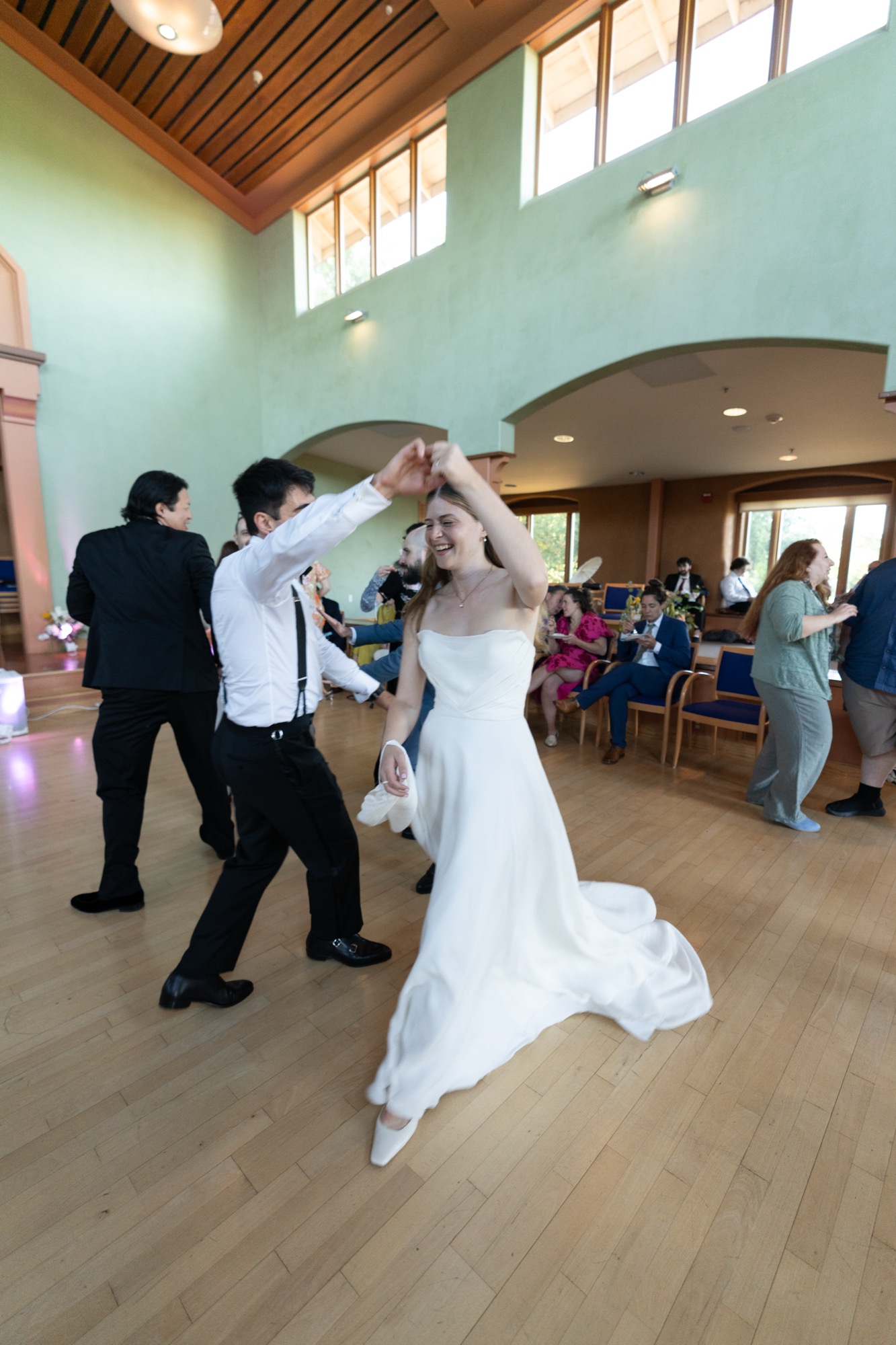 The bride being twirled on the dance floor