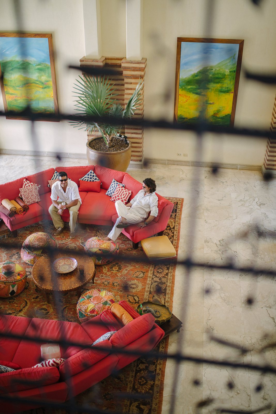Red cushions seen through a carved screen