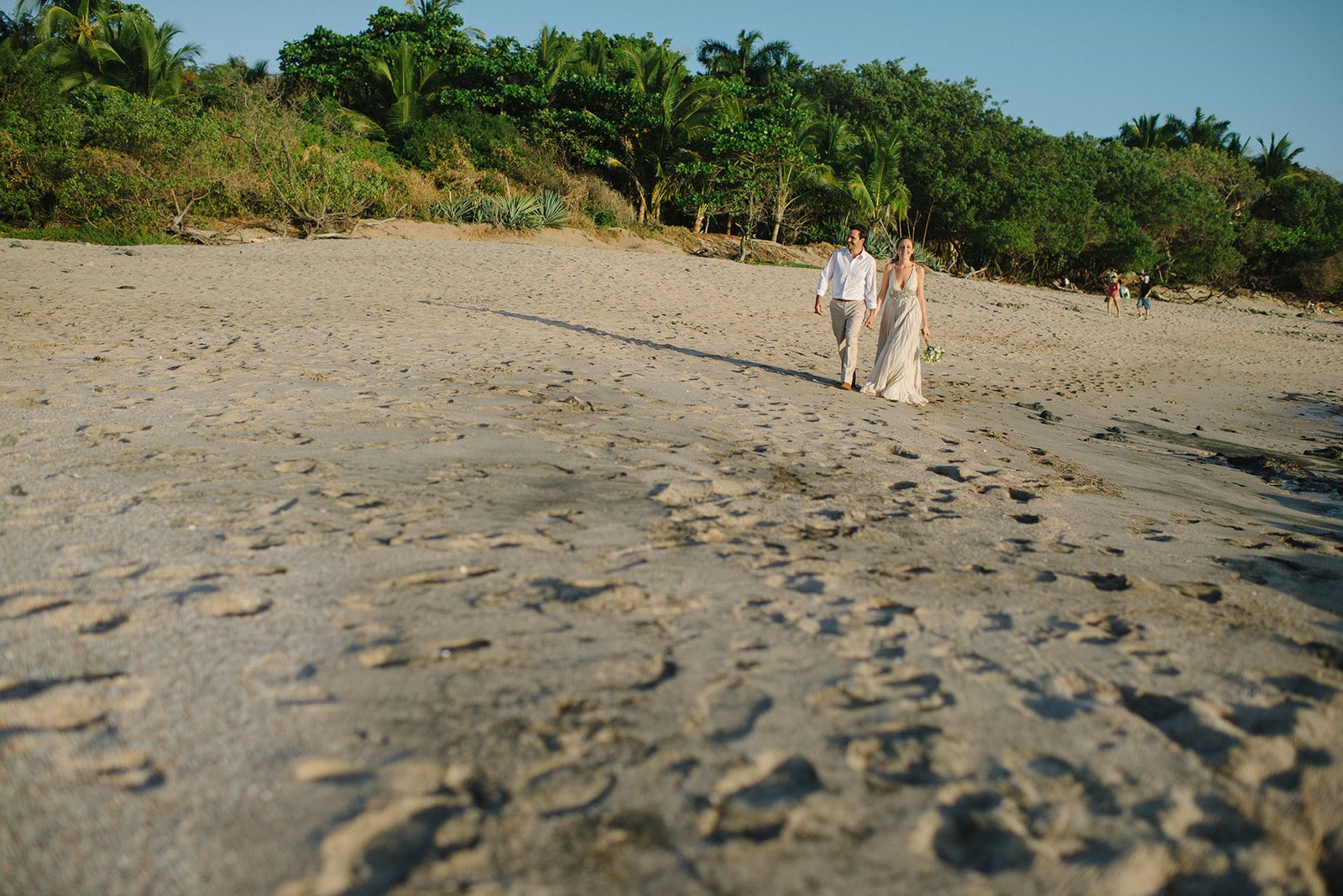 The couple walking the beach
