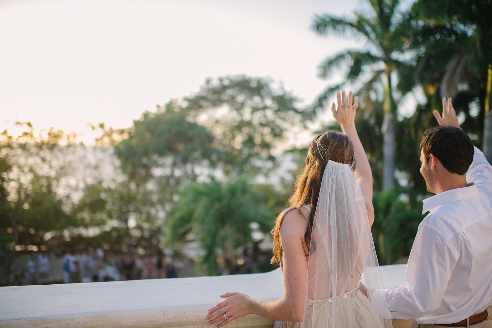 The bride waving from the terrace