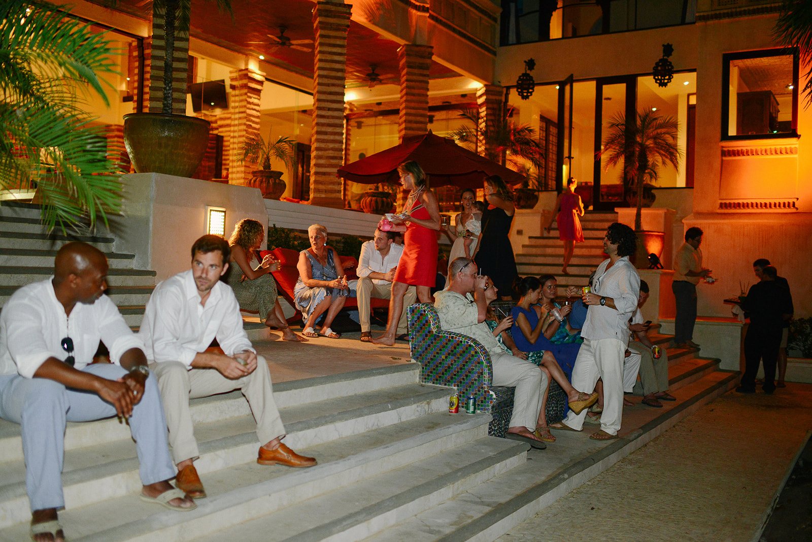 Guests gathered on lit steps at night