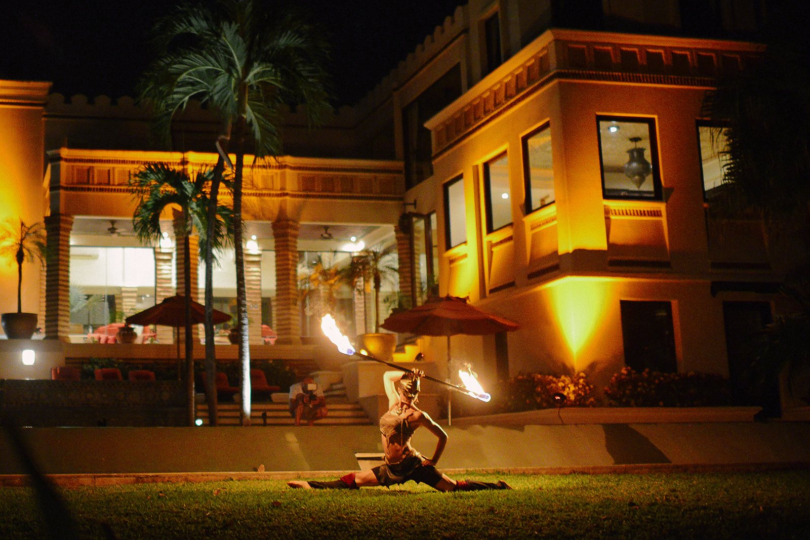A fire dancer in front of the house