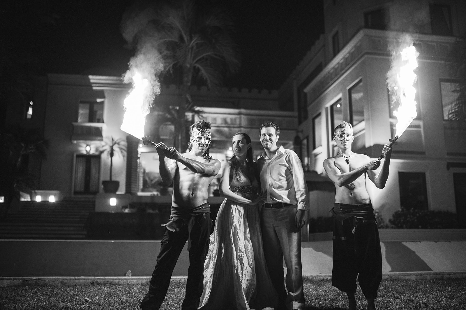 The couple with the fire dancers, in black and white