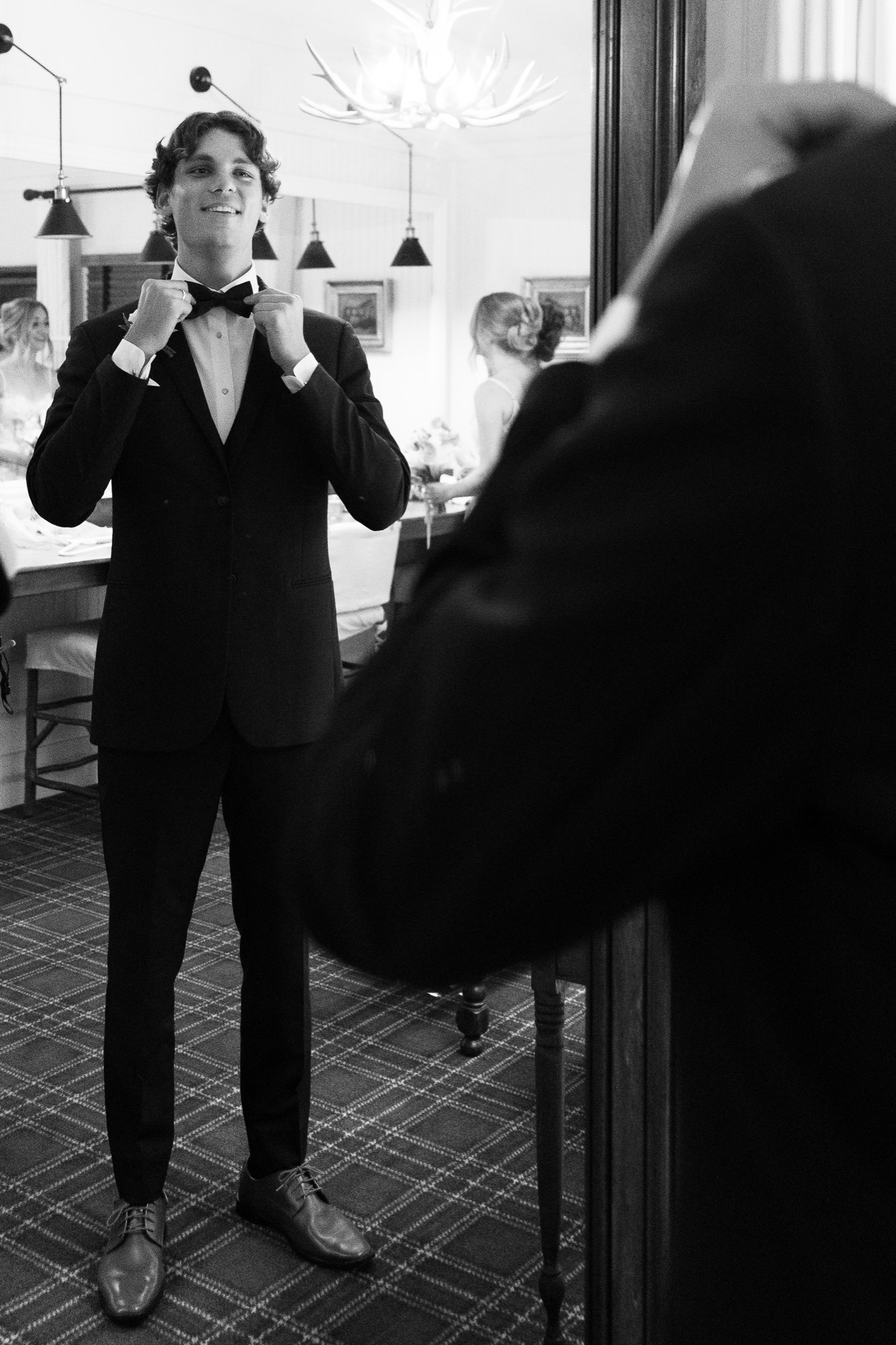 The groom getting ready, in black and white