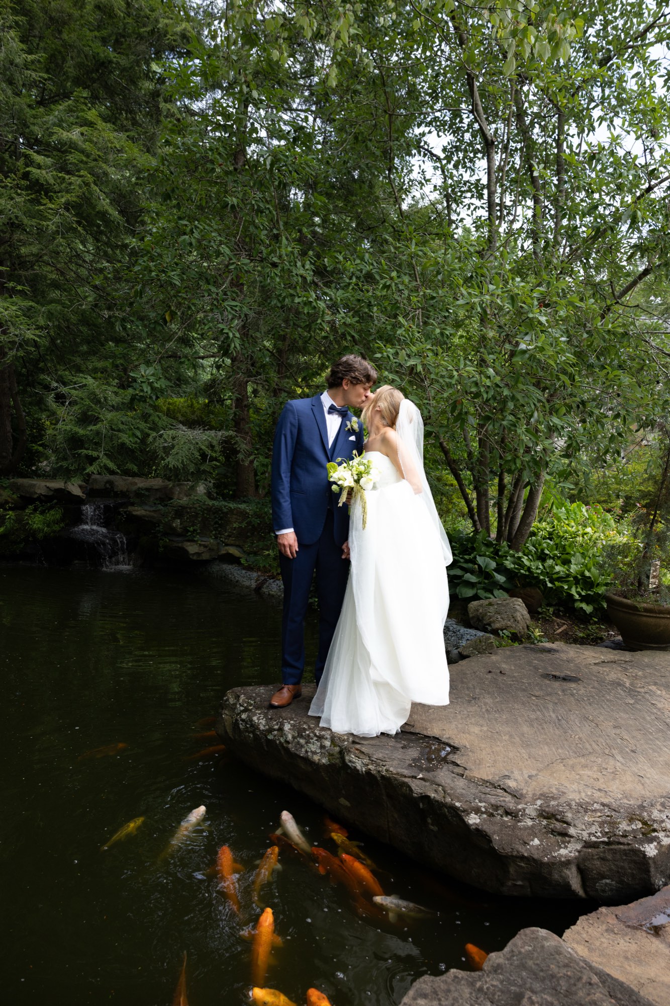 The couple on a stone beside the koi pond