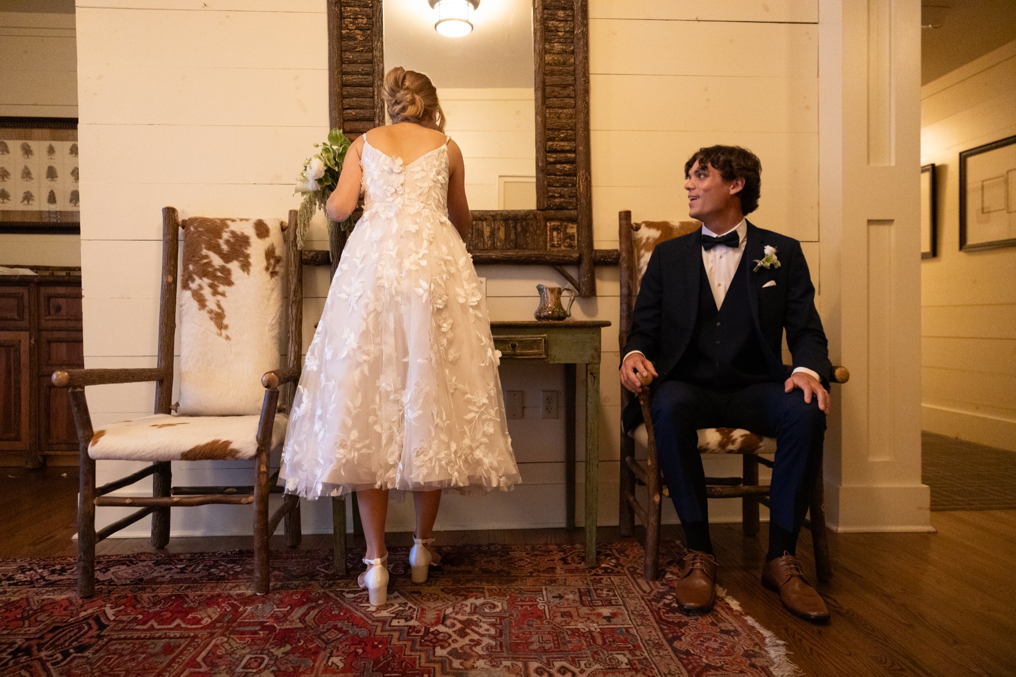 The couple in an antique room, the bride in lace