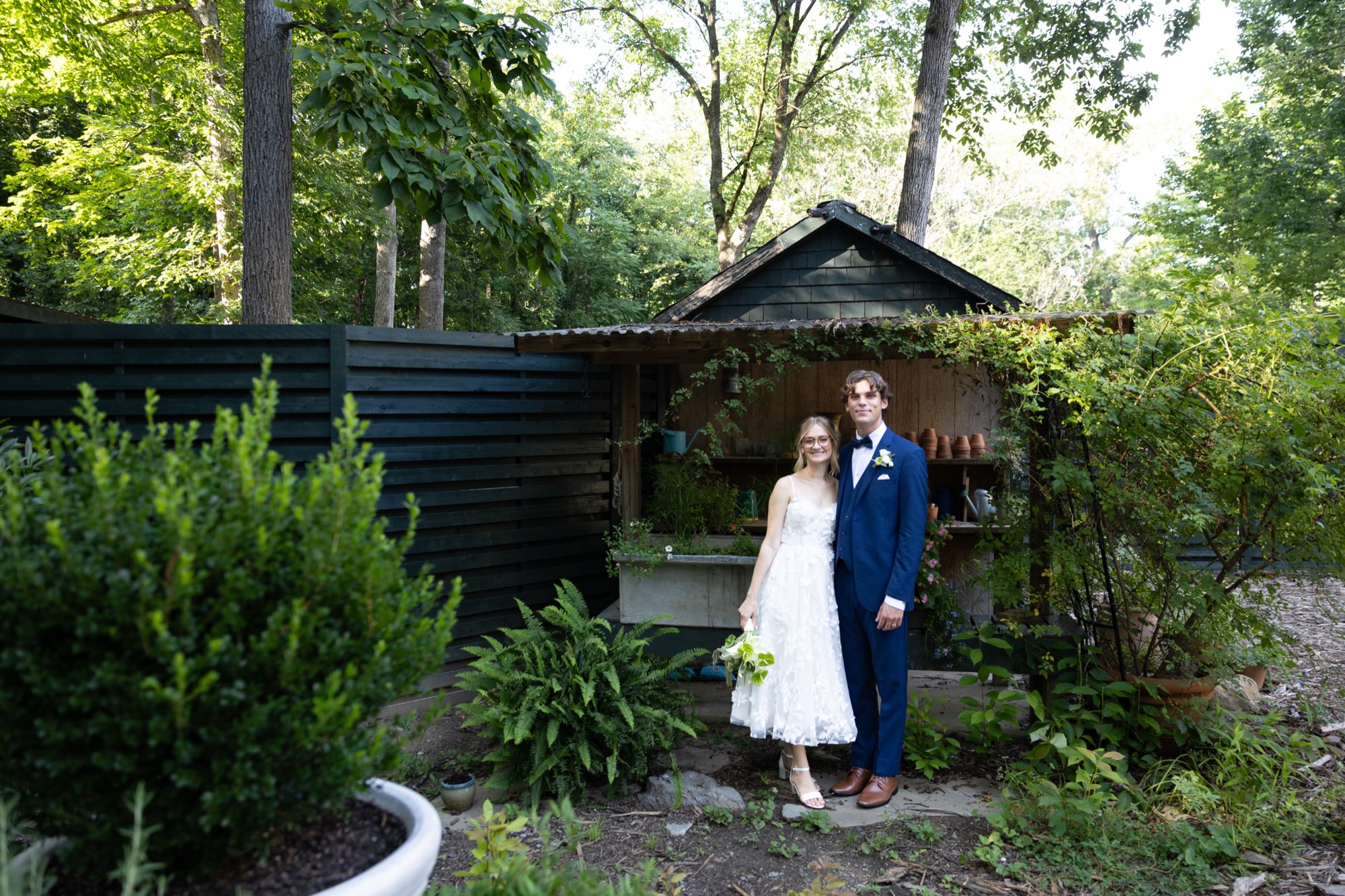 The couple in front of a garden shed