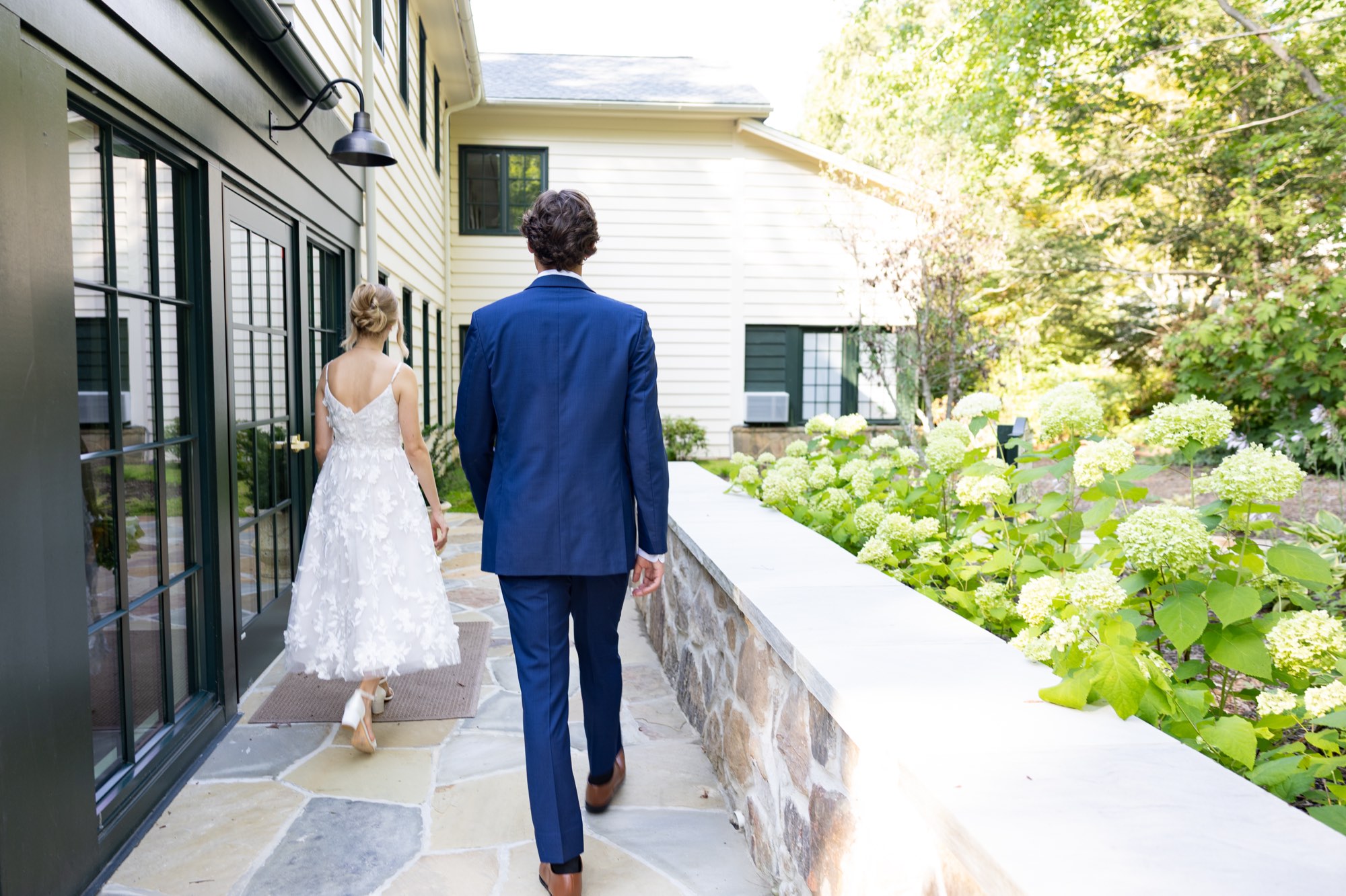 The couple walking down a sunny terrace