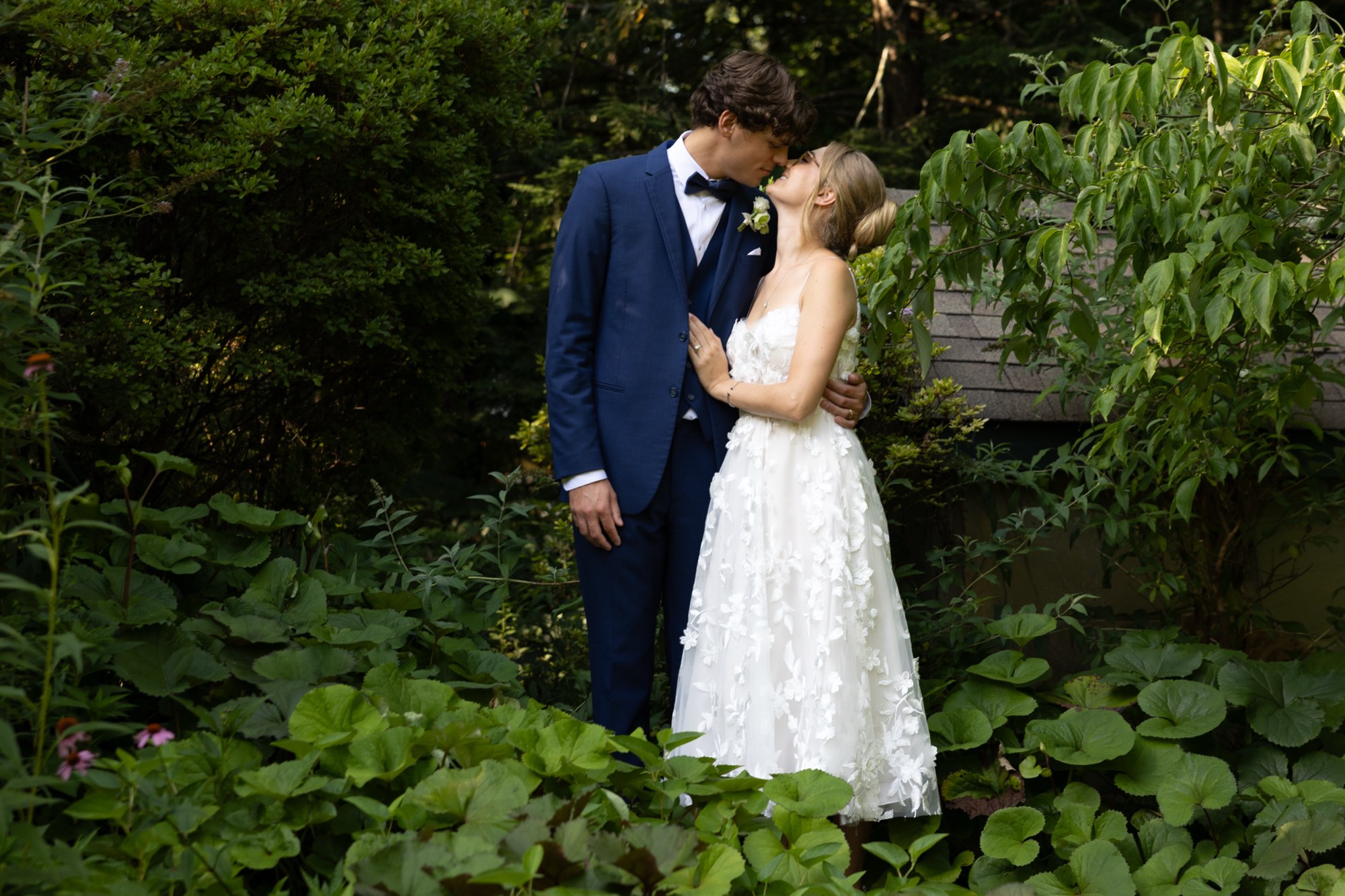 The couple kissing in deep greenery