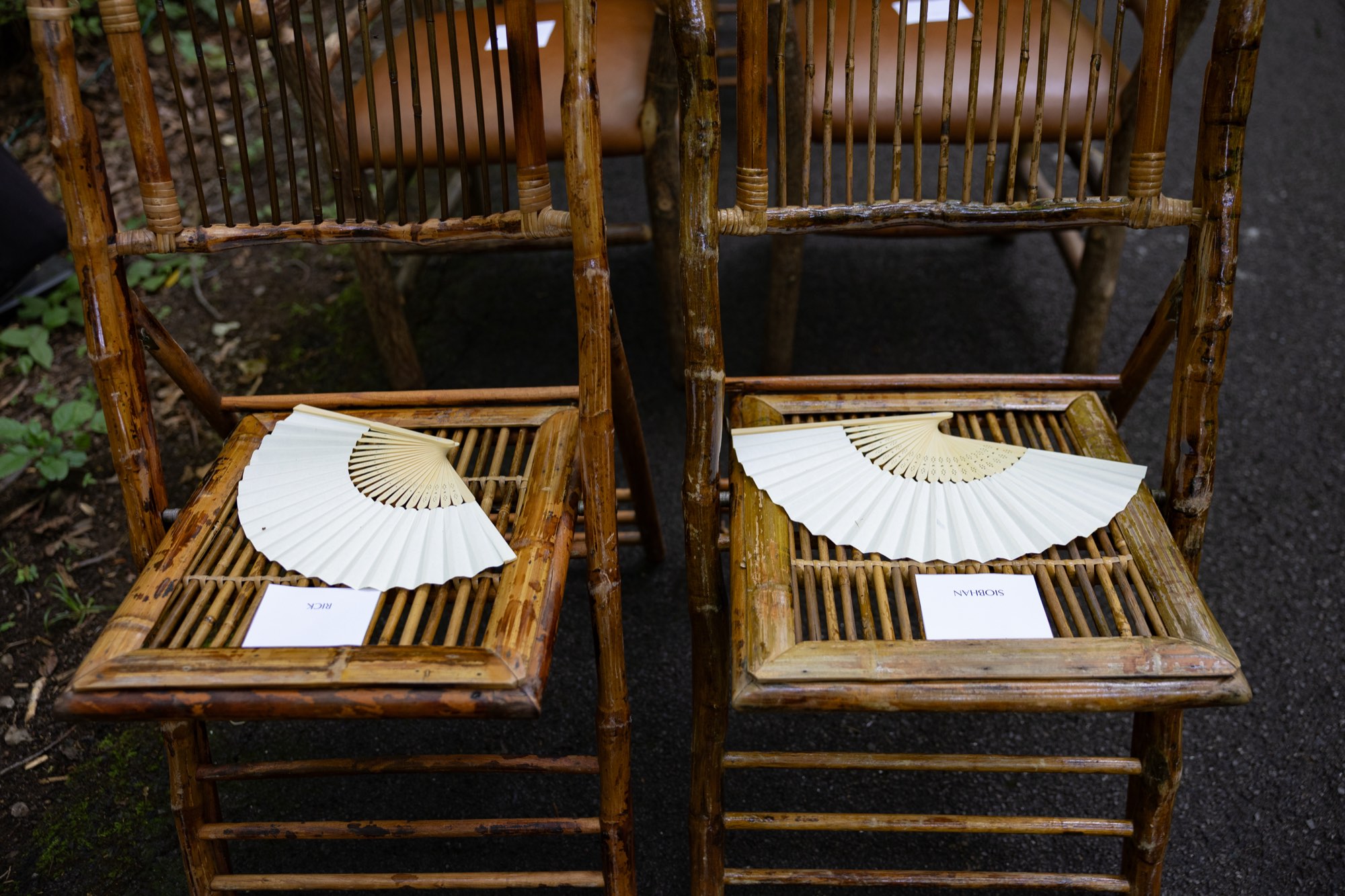 Bamboo chairs with paper fans on the seats