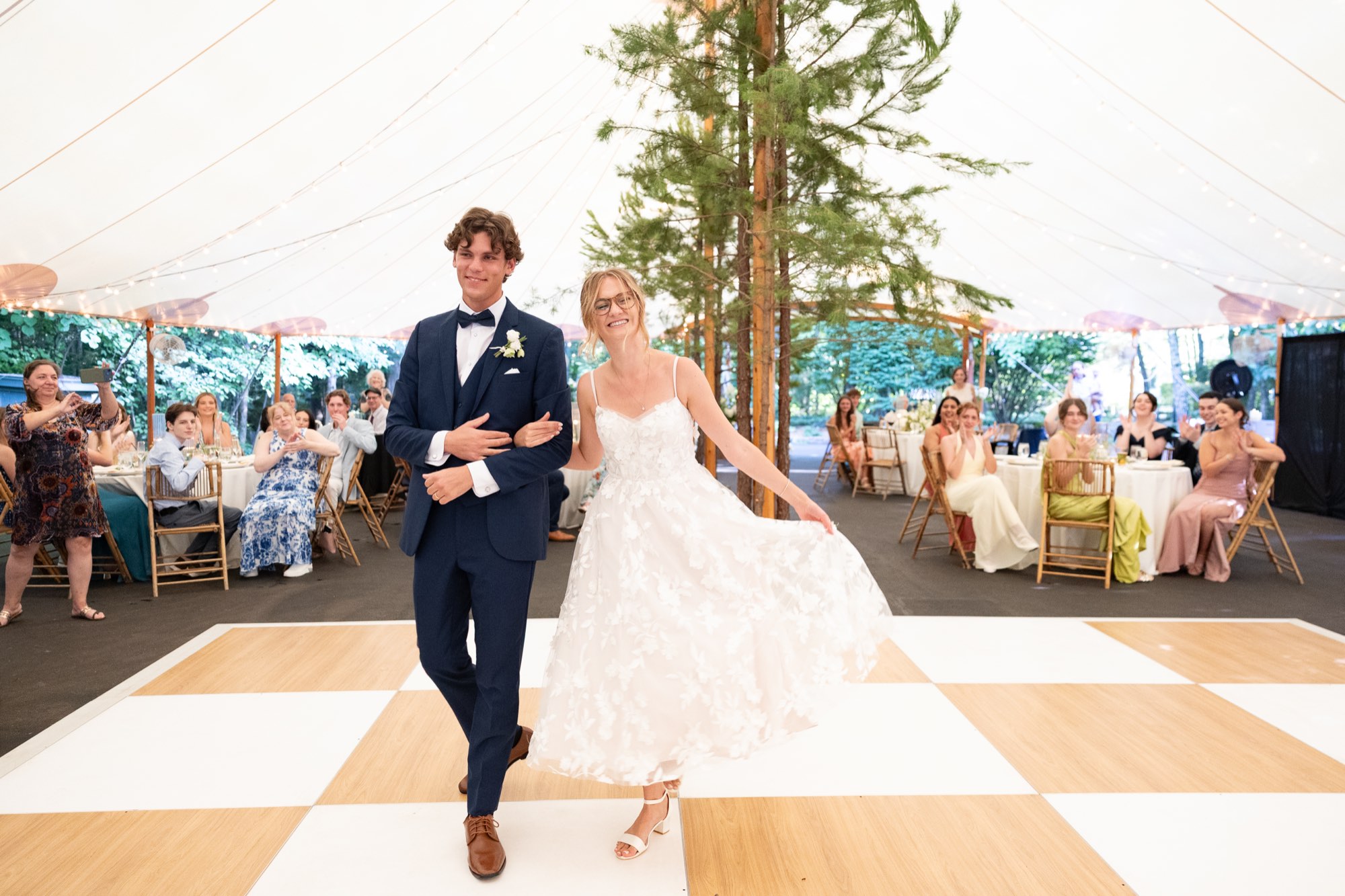 A first dance on a checkered floor in a tent